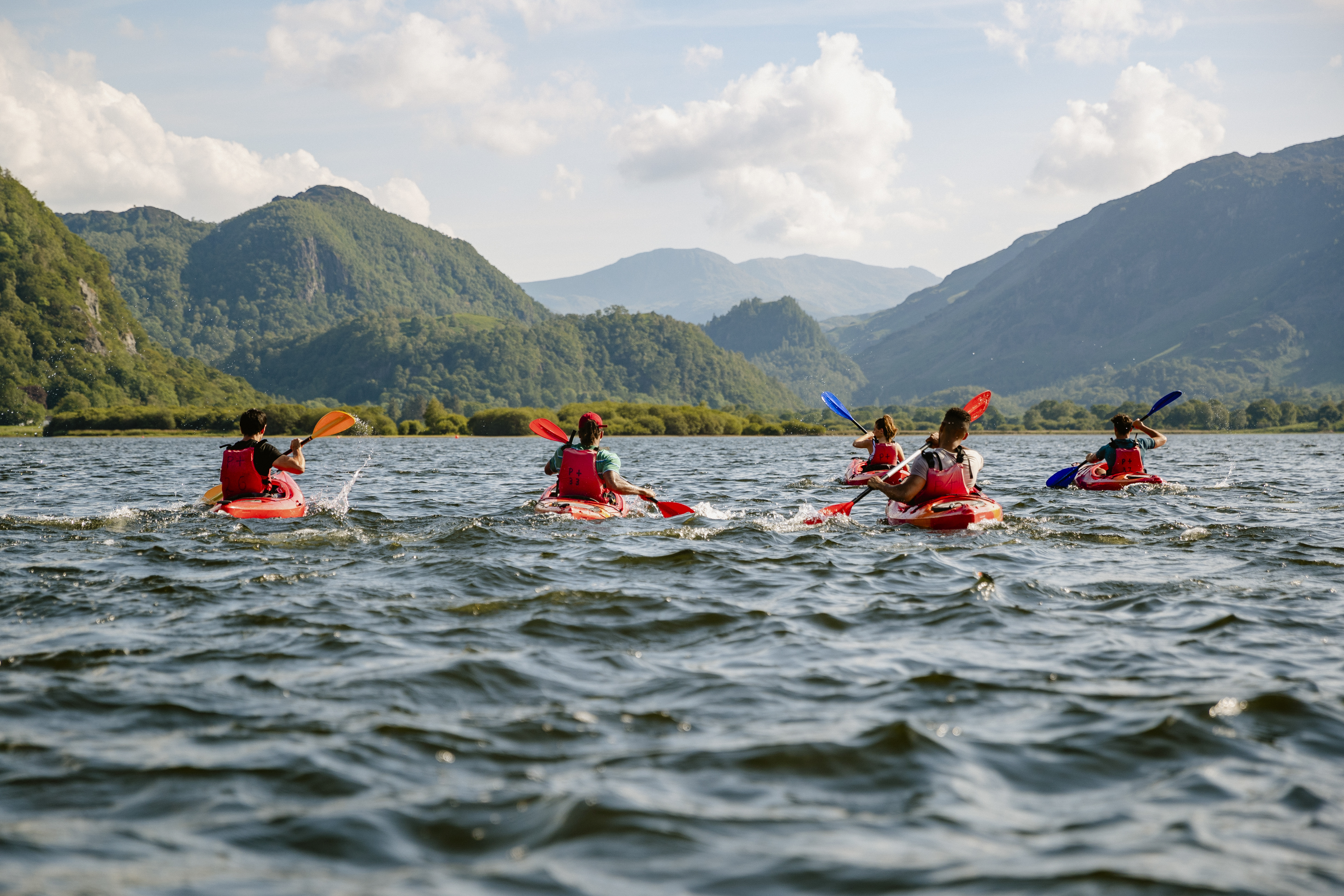 The Lake District in Cumbria Group learning to kayak across water on Derwent Water in The Lakes District in Cumbria