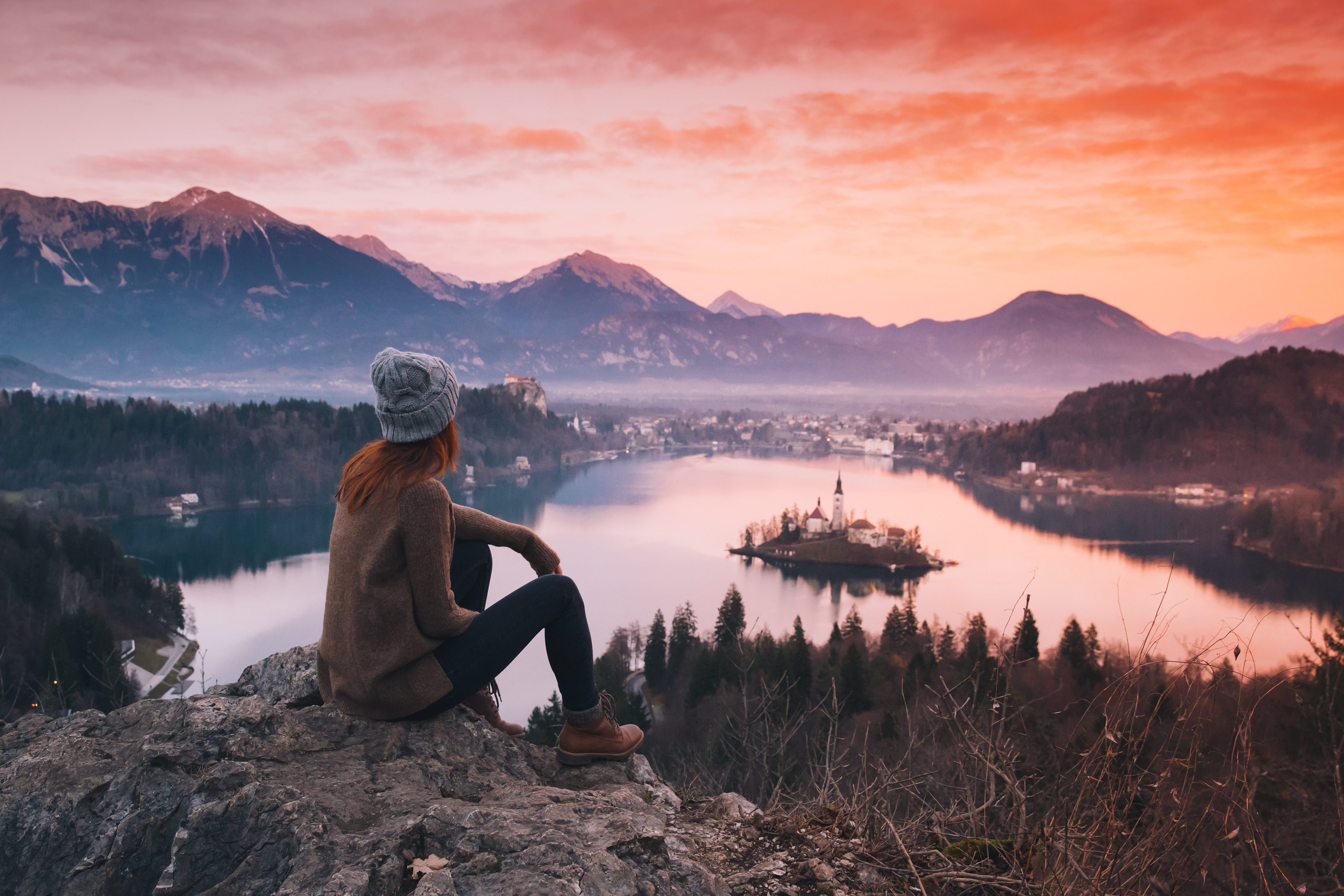 Woman looking on Bled Lake with Island, Castle and Alps Mountain on background