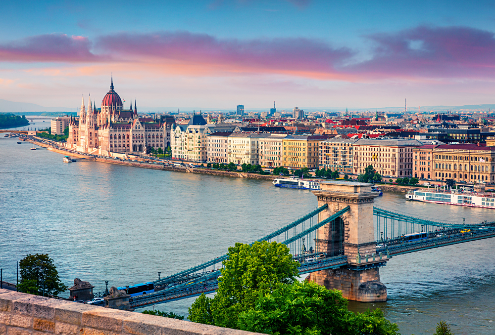Colourful evening view of Parliament Building and Chain Bridge in Pest city, Budapest, Hungary