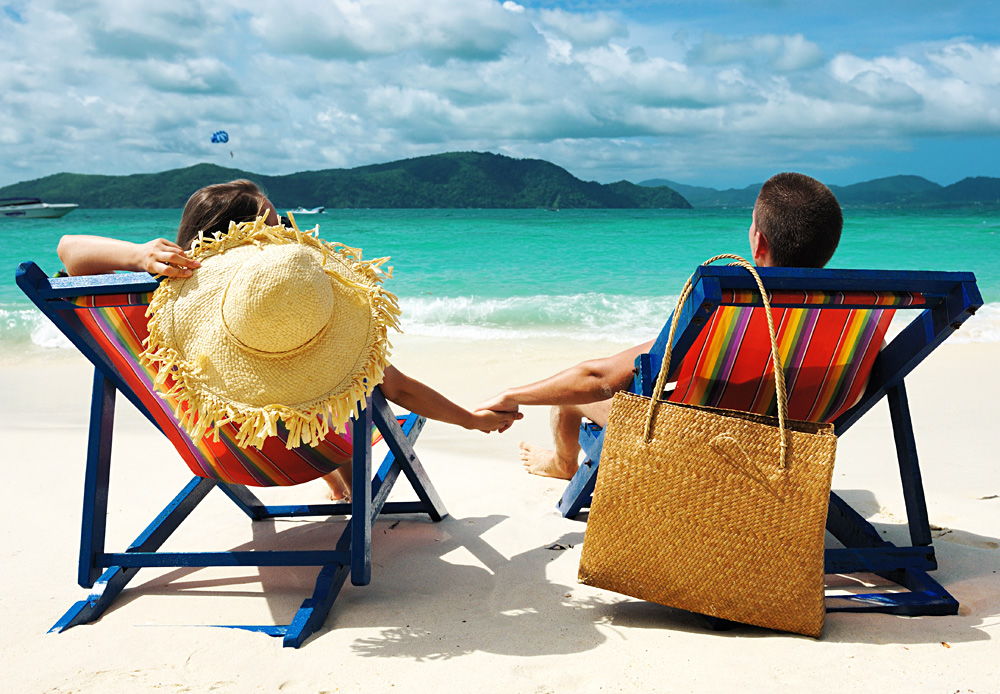 Couple holding hands on a Beach in Phuket, Thailand