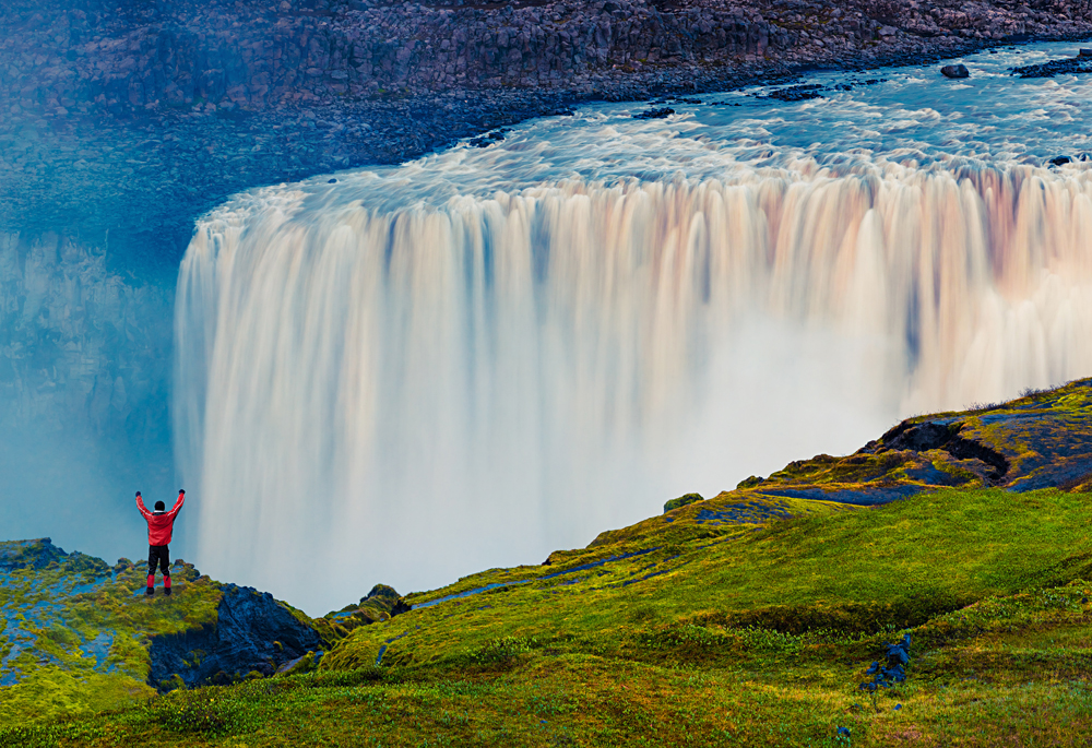 Standing in front of the powerful Dettifoss Falls, Jokulsargljufur National Park, Iceland