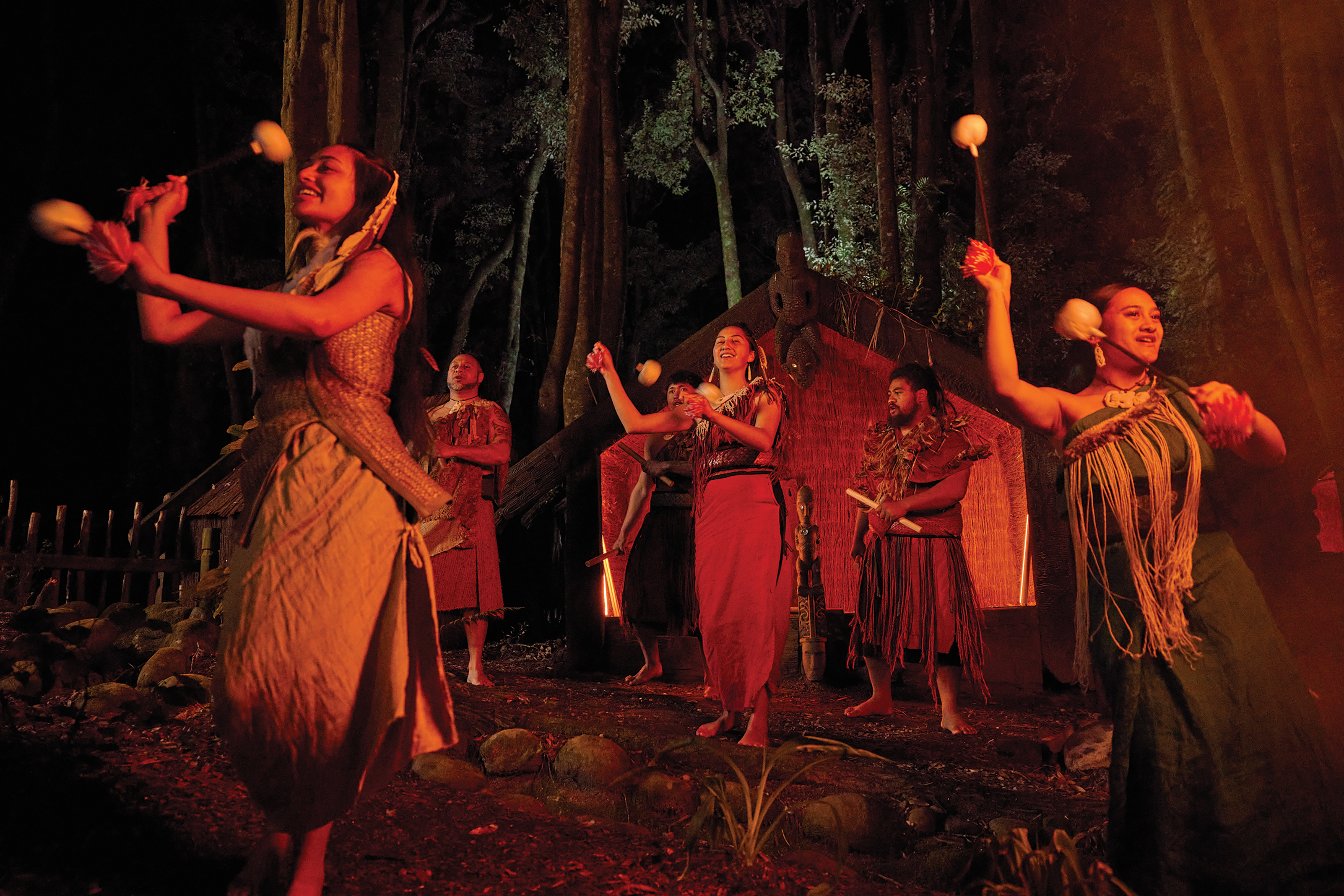 a group of Maori dancers show their moves with traditional outfits