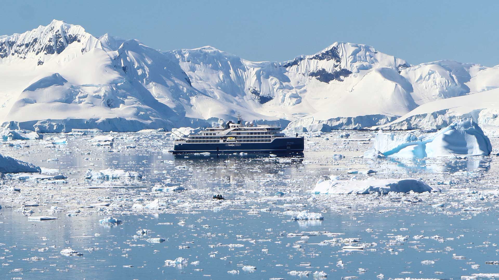 cruise vessel with icebergs and ocean surrounding
