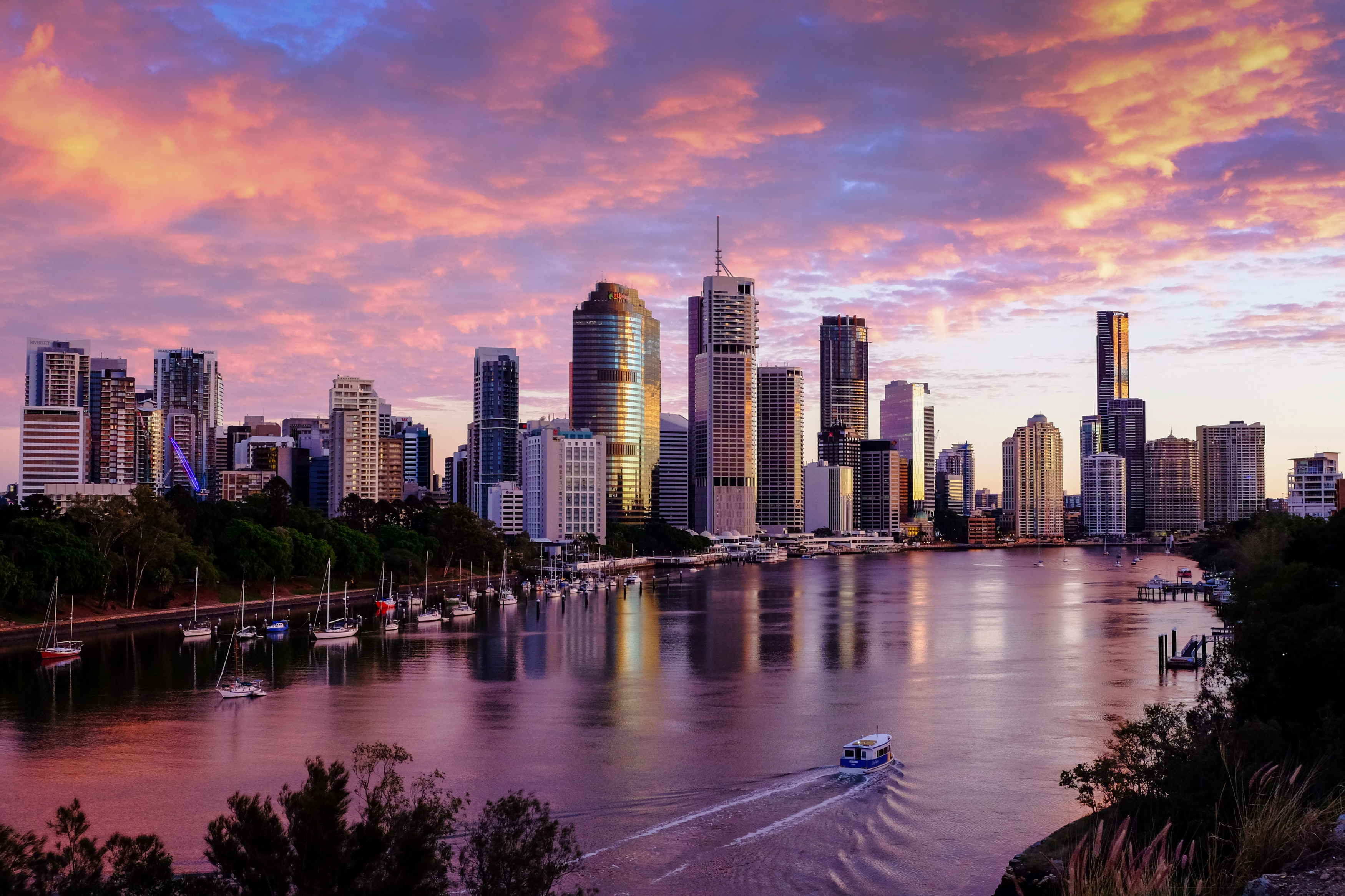 purple sunset over a city with river in foreground