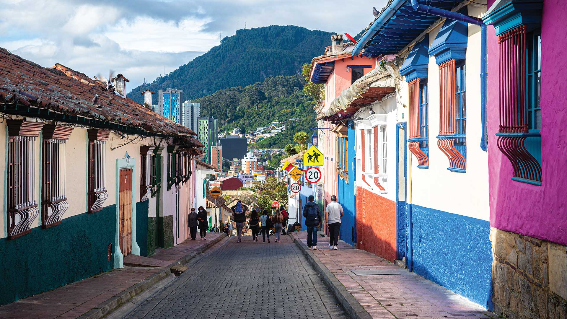 colourful homes on street with background mountain