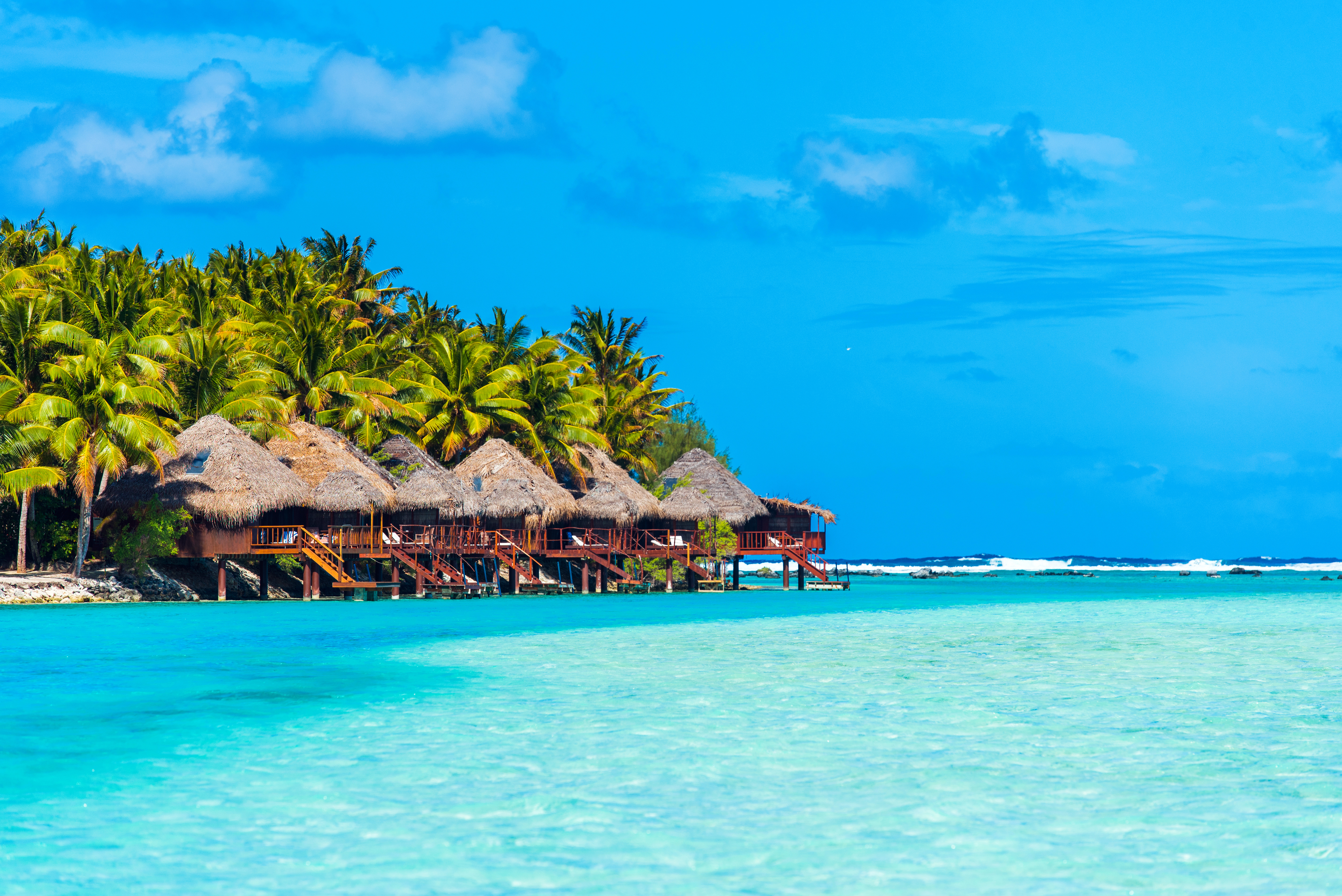 gorgeous island villas line the pristine beaches and clear waters of Aitutaki in the Cook Islands