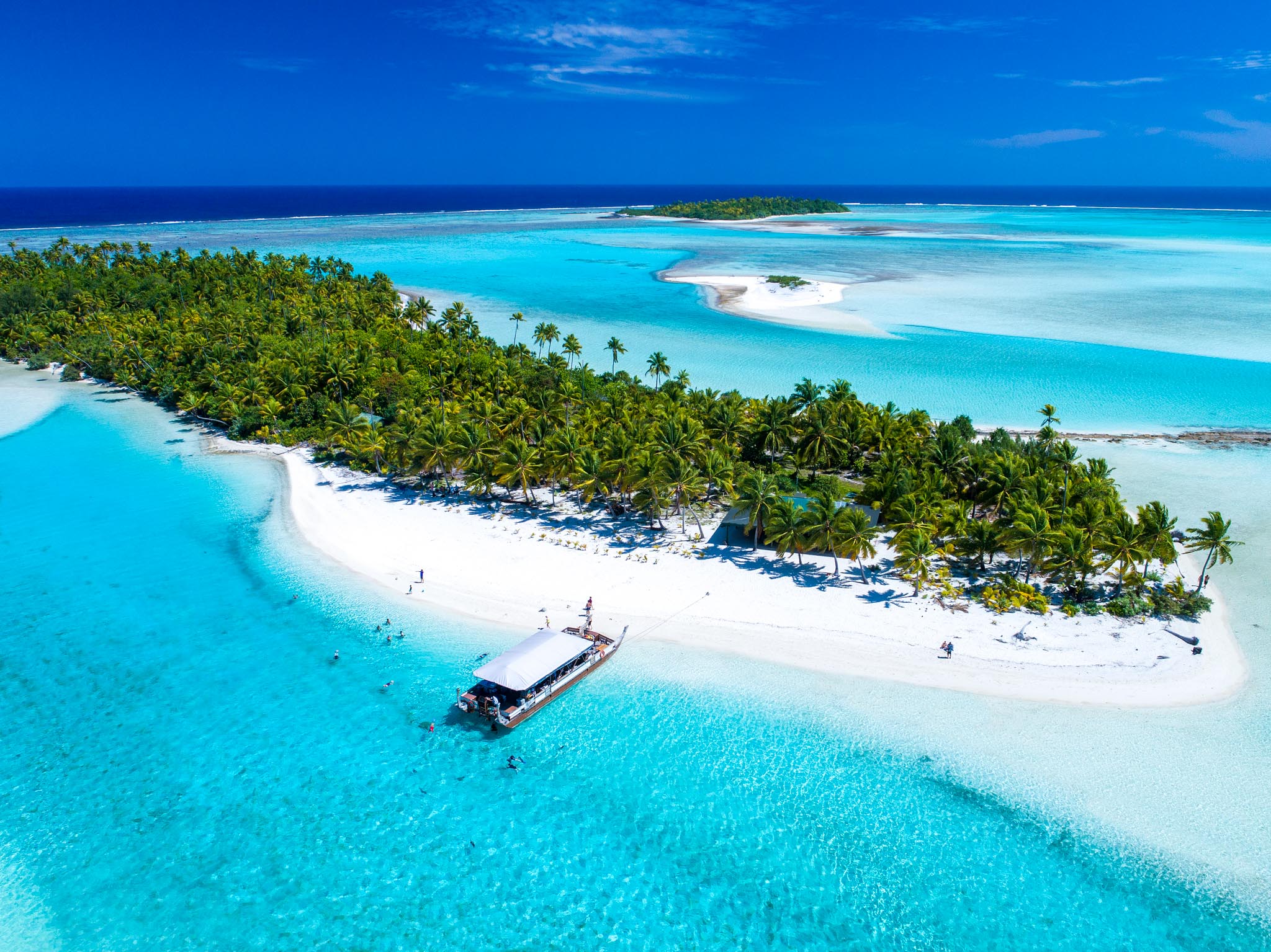 aerial view of a white-sand beach and island
