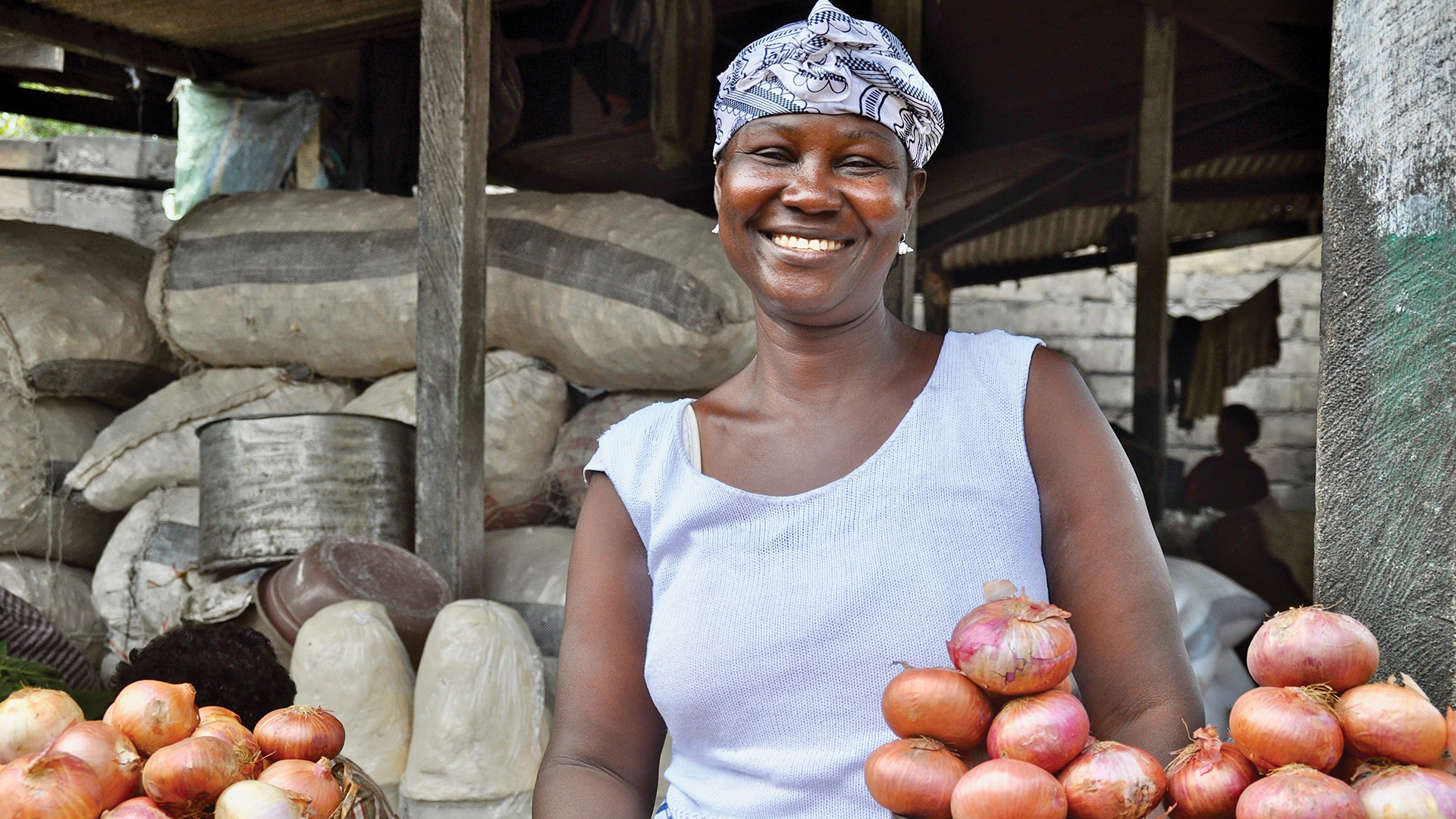 A smiling woman at a market in Ghana