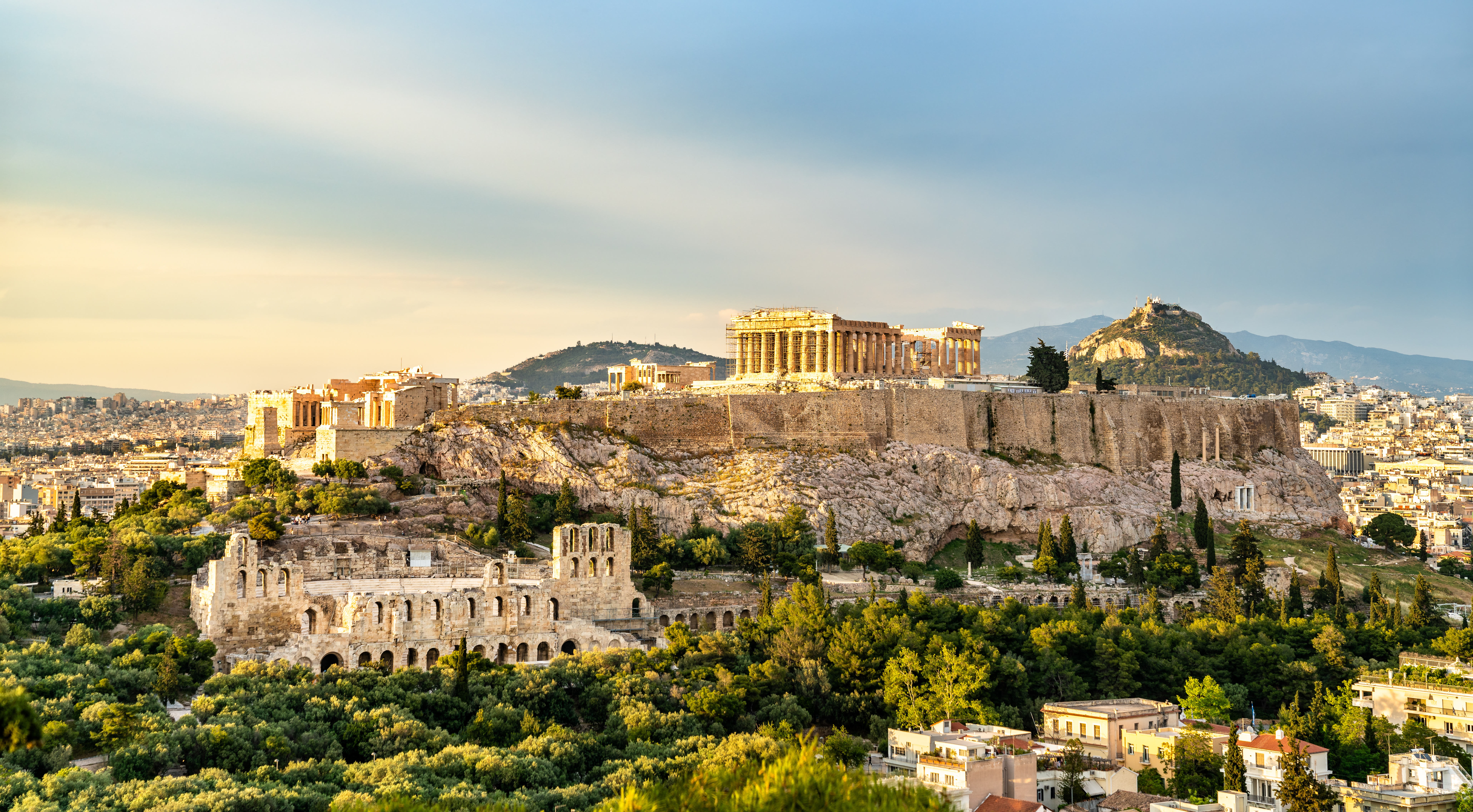 ancient ruins on a hill overtop a city