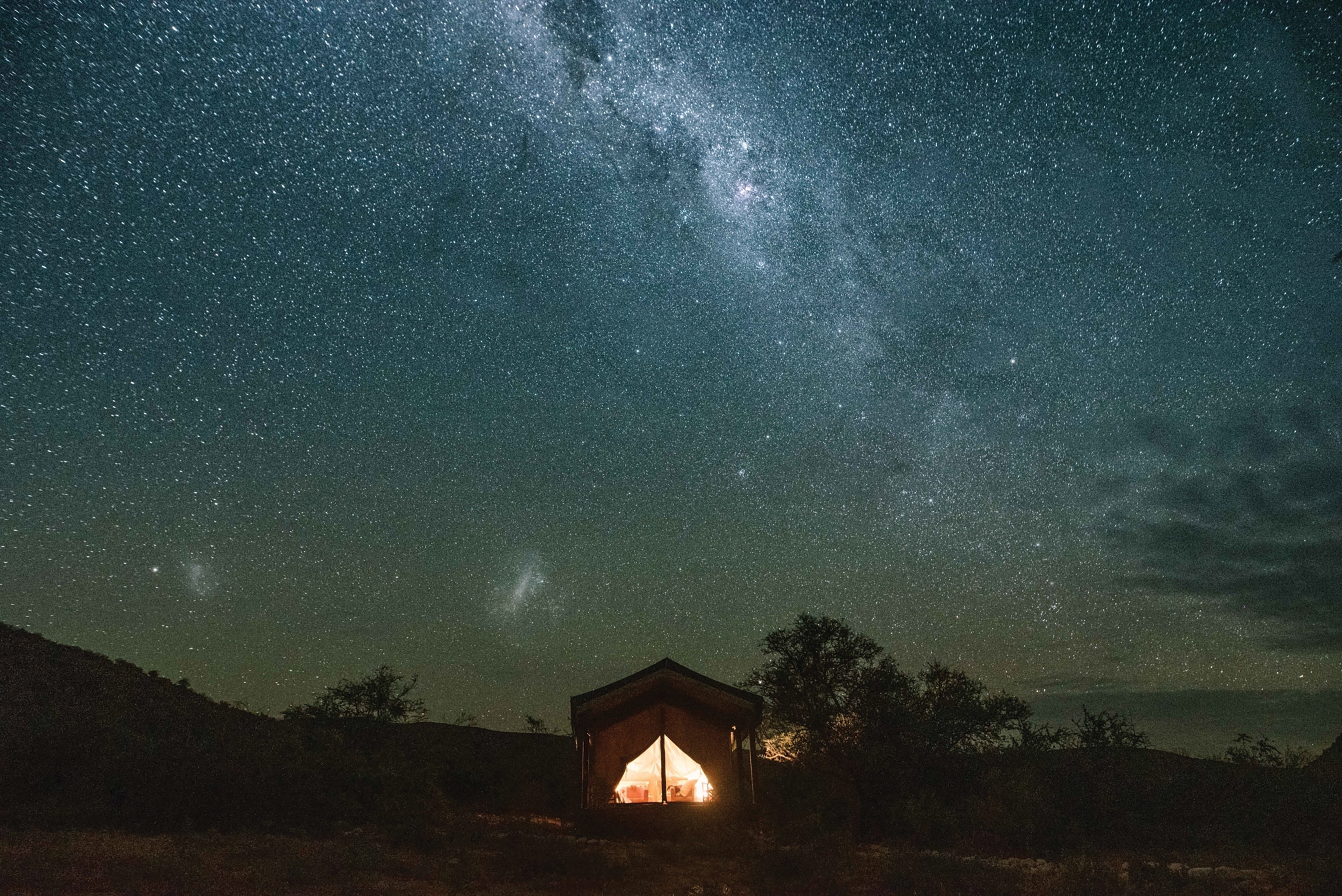 The brilliant colours of the Milky Way light up the dark wilderness of a tent on the Western Cape.