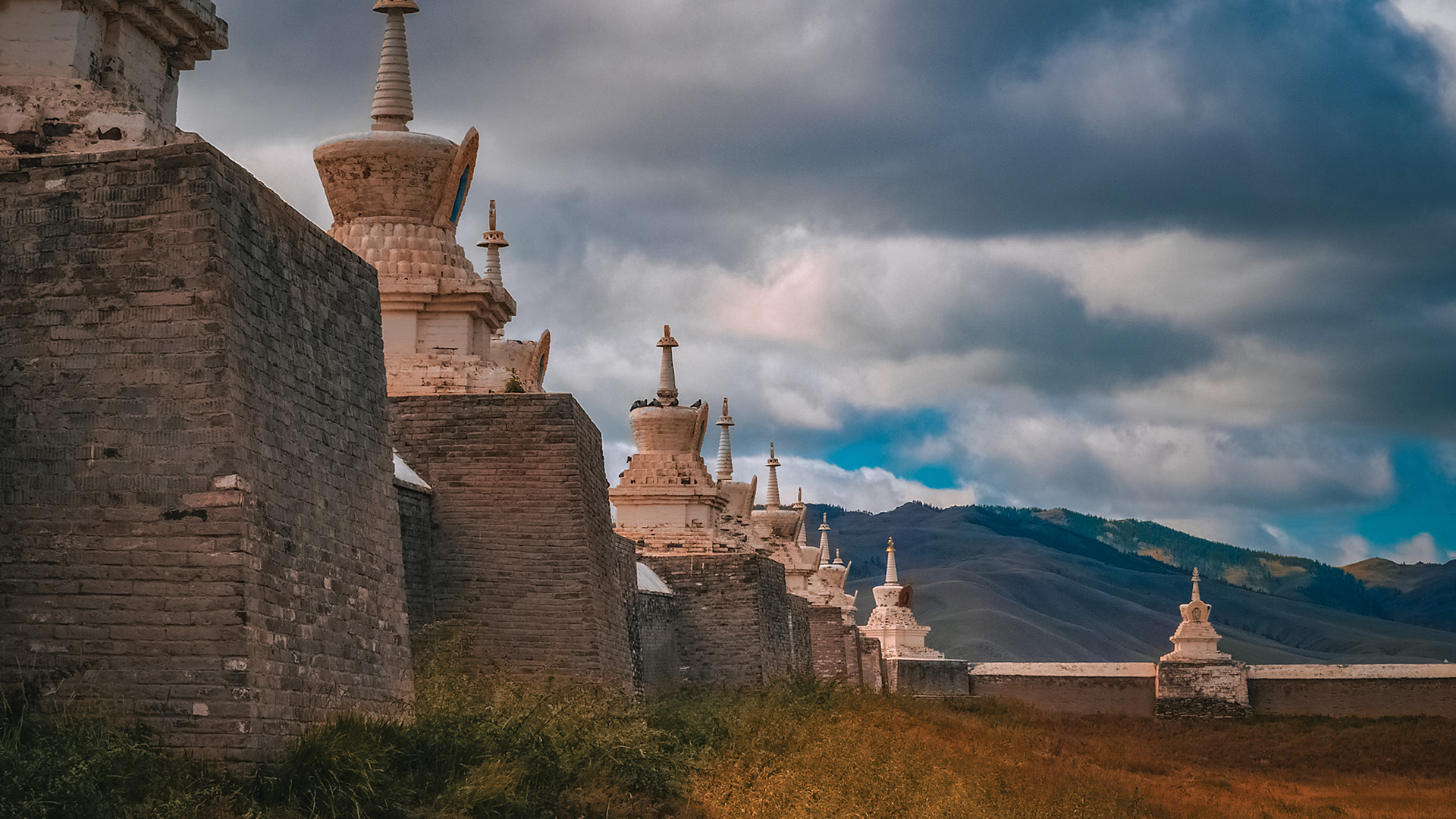 Mongolia's Erdene Zuu Khiid Monastery in front of a mountain range