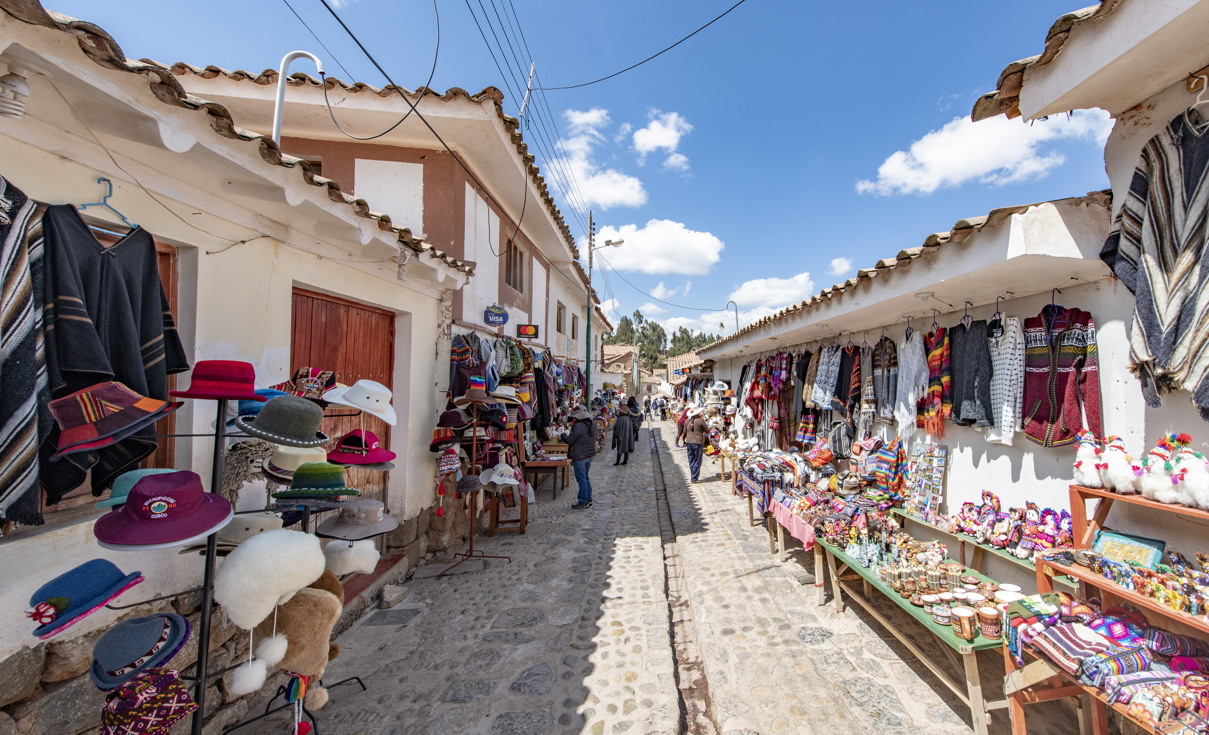 Locals selling souvenirs on a street in the village of Chinchero. The village is located at 3700 m above sea level, surrounded by the Andean mountains, at the Sacred Valley in Peru.