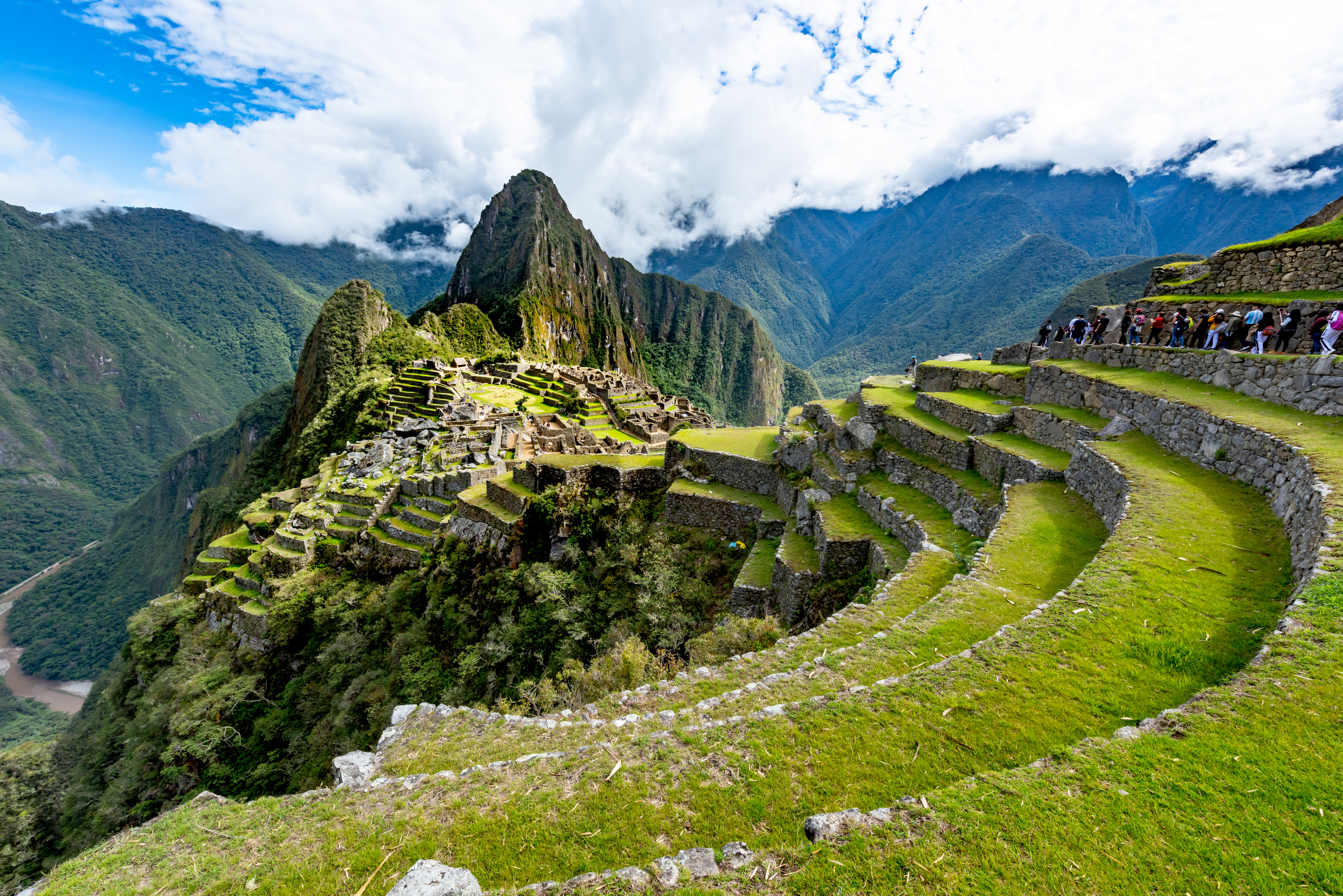Machu Picchu aerial view. Tourists are walking through the old abandoned city.