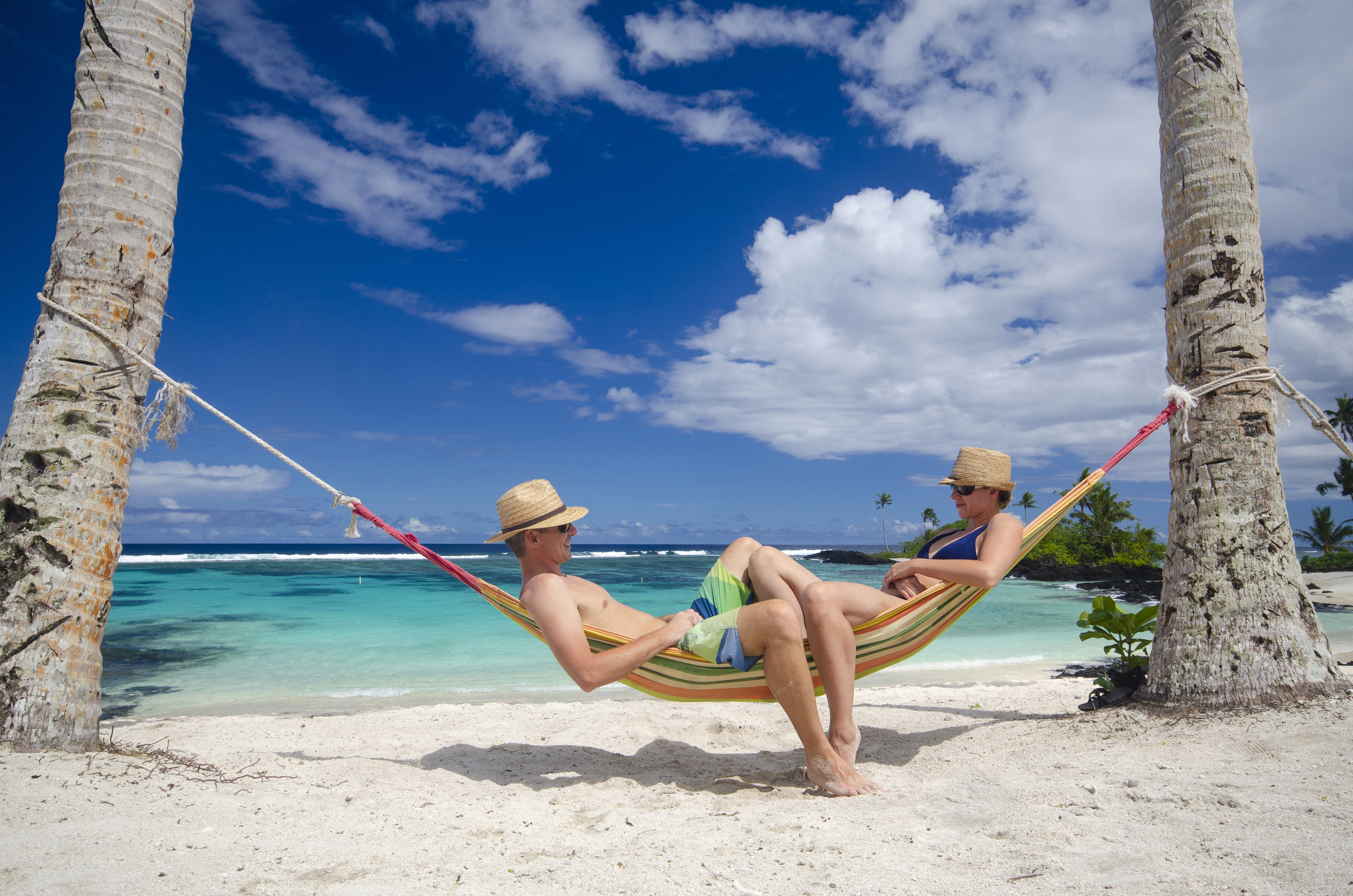 Couple relaxing in hammock on a beach