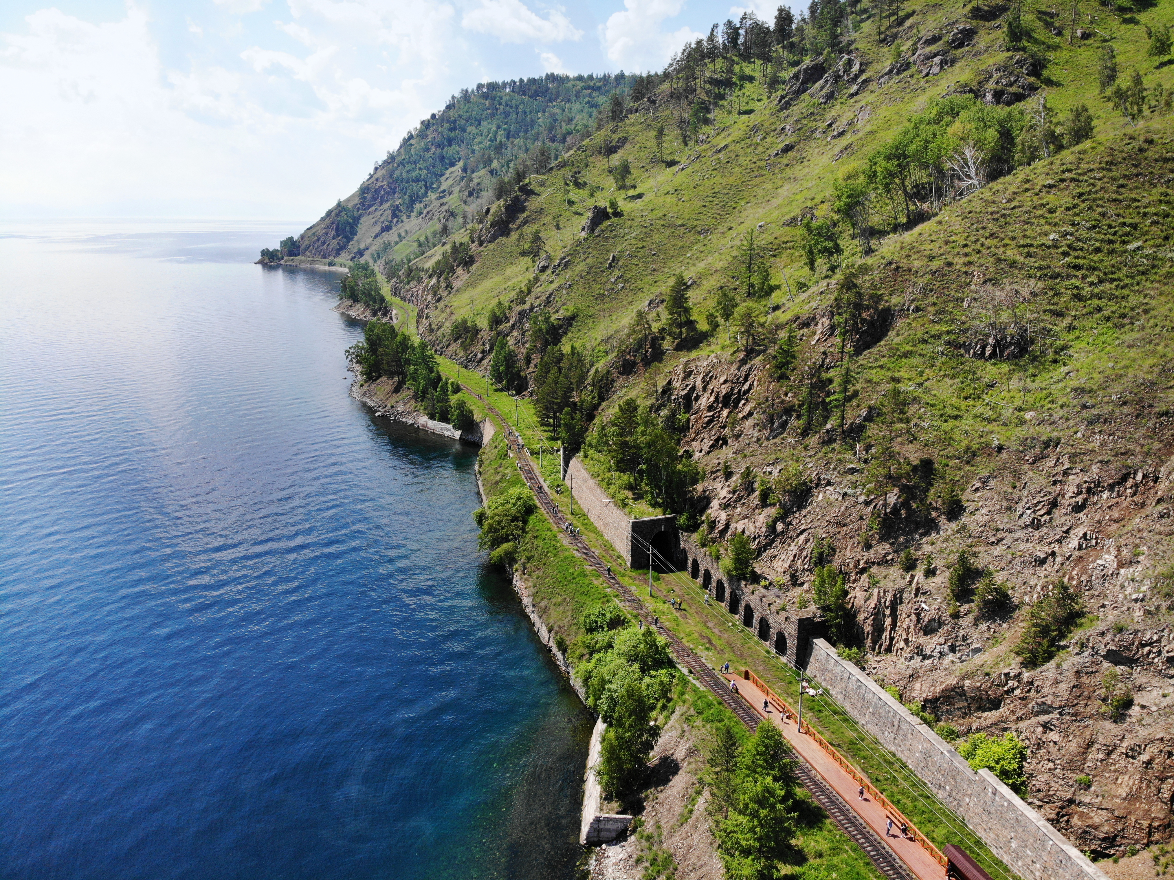 Baikal lake. Old stone arch tunnel and stone wall in mountain the rock on the Circum-Baikal railway in summer