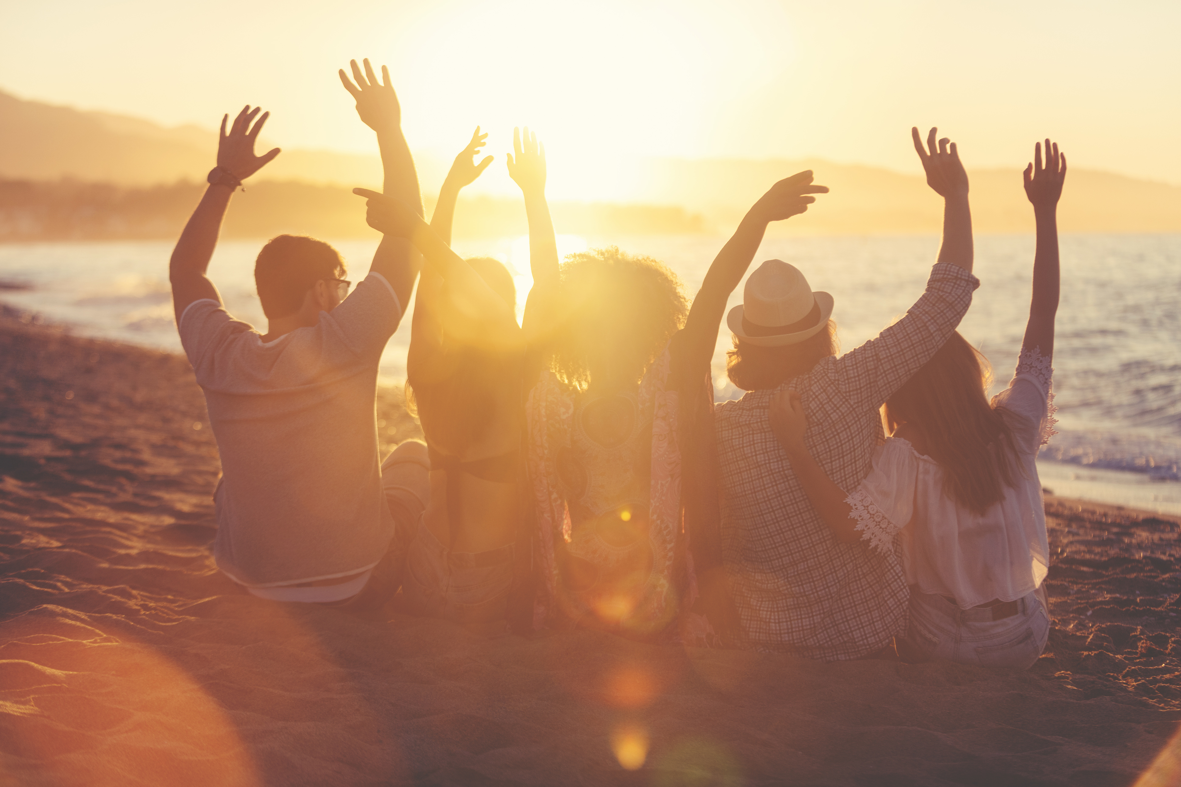 Group of friends sitting on the beach