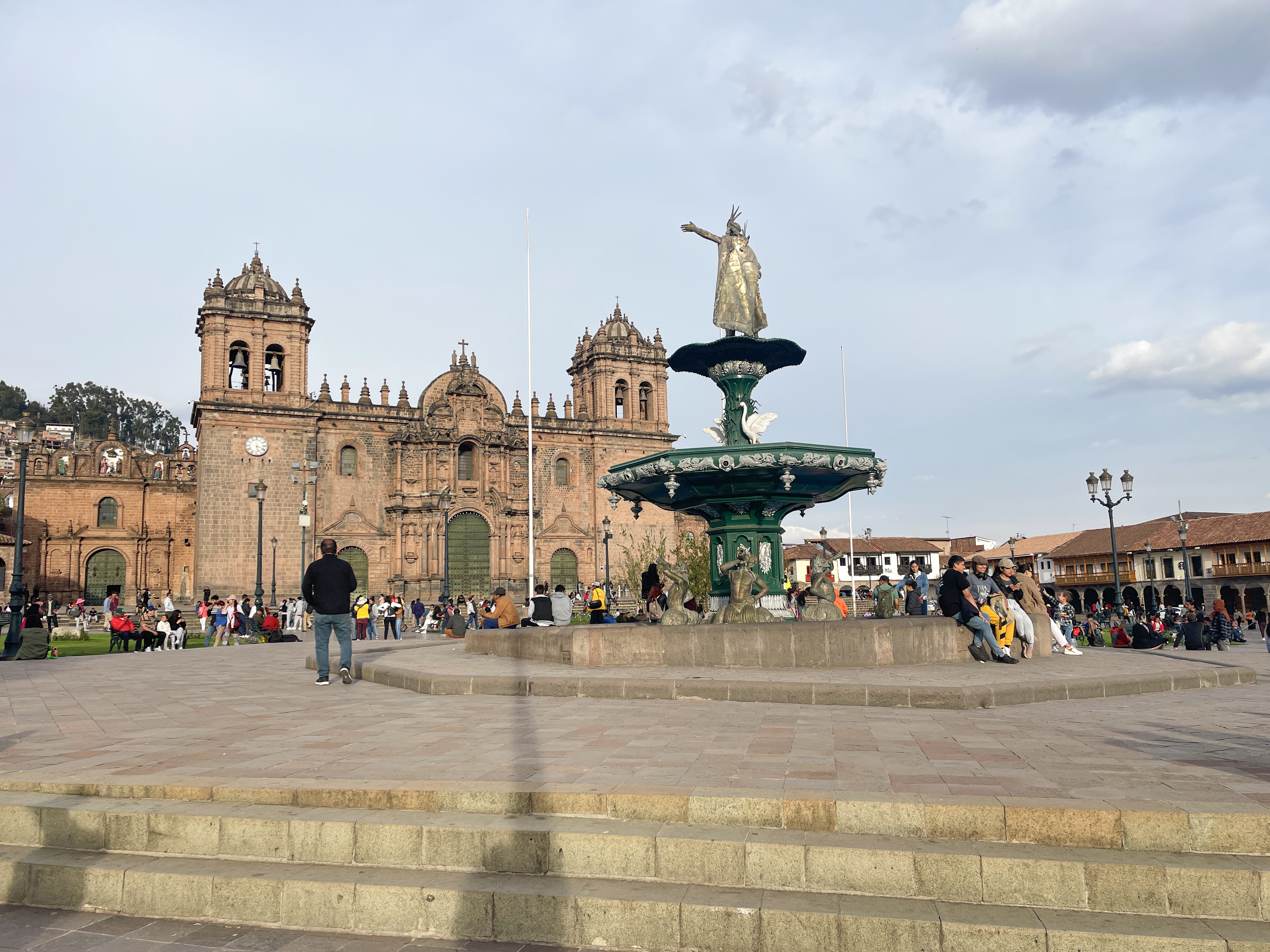 View of the Cathedral of Cusco in the Plaza de Armas and and statue of pachacuti, with people visiting- Cusco, Peru