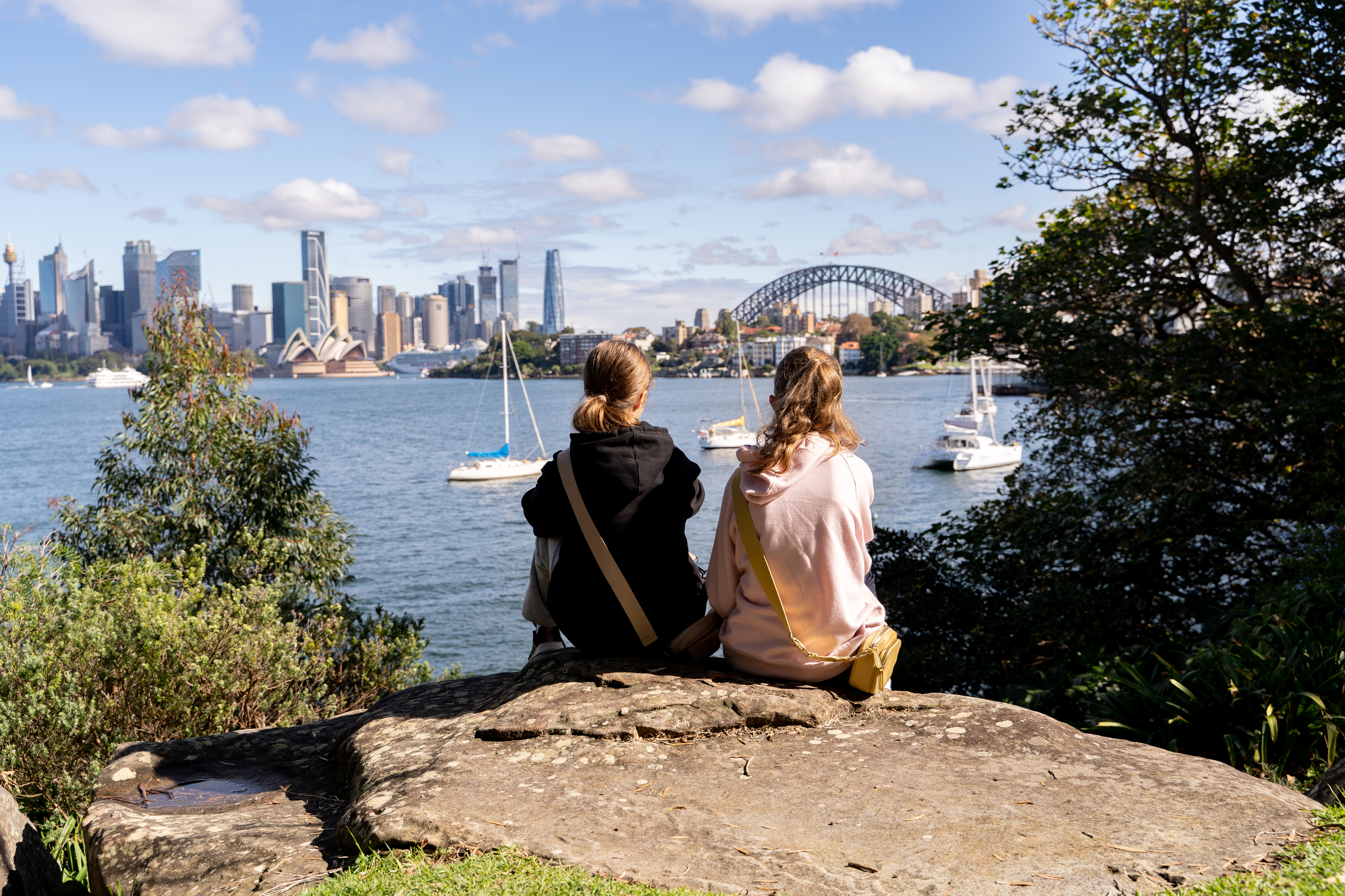 Two young girls looking at Sydney harbour.