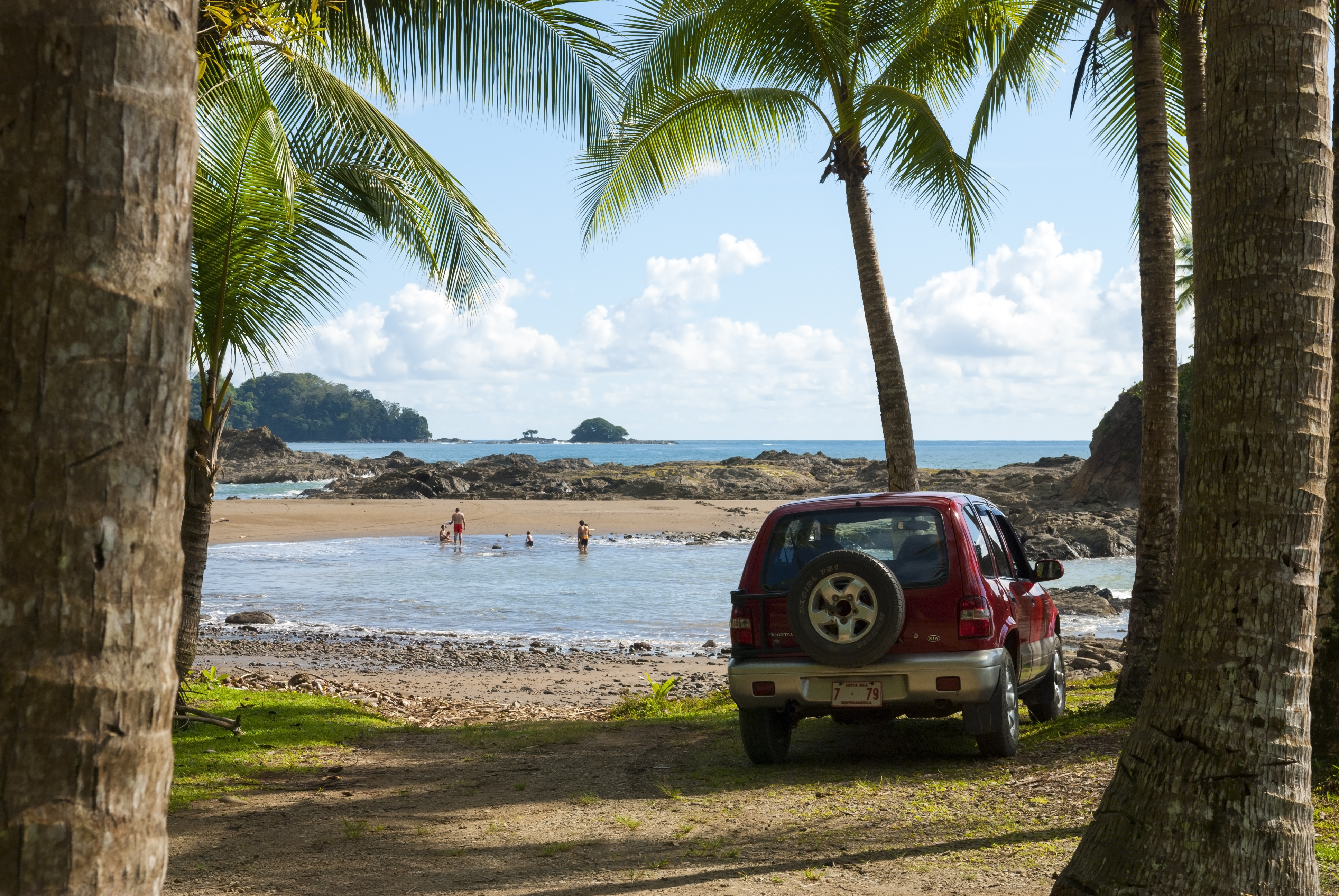 Vehicle and family at the tropical beach