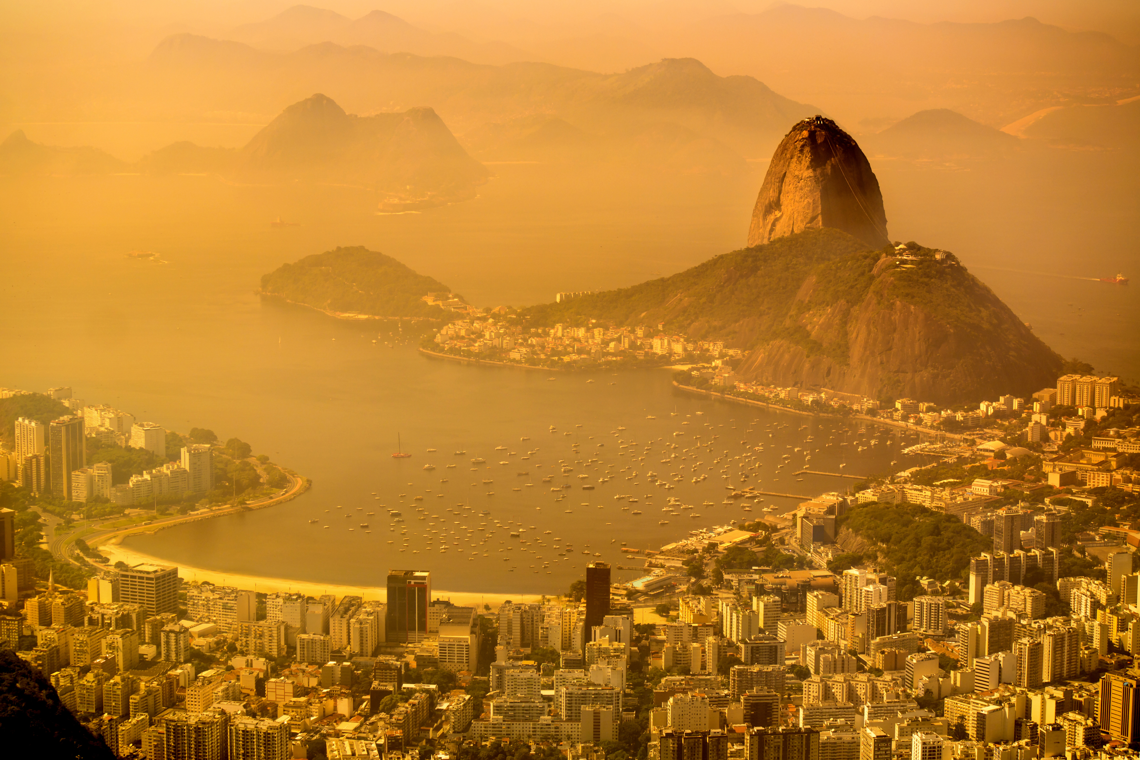 Aerial view of Rio de Janeiro with sugarloaf mountain and Guanabara Bay at background.