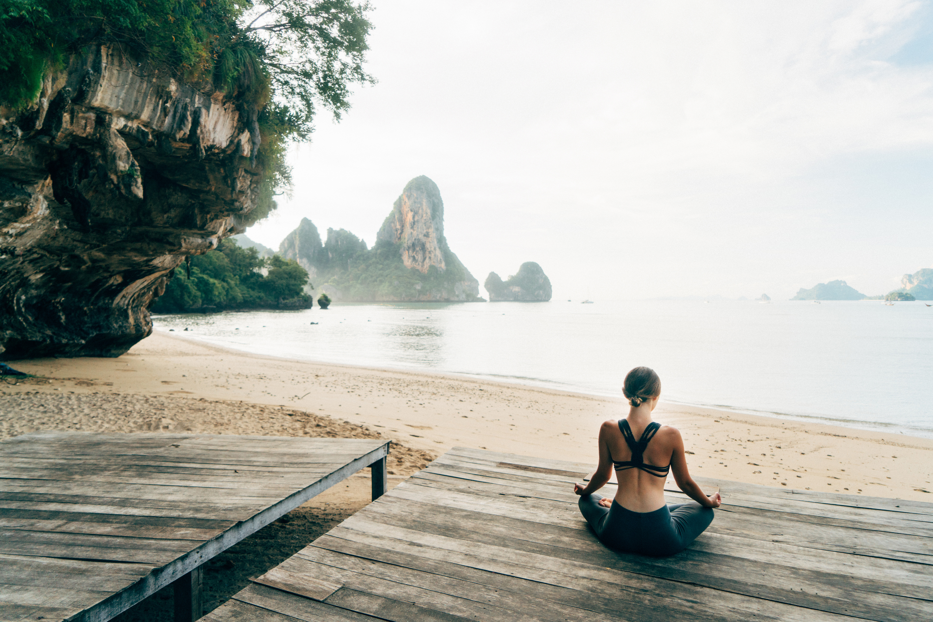  Woman doing yoga on the beach