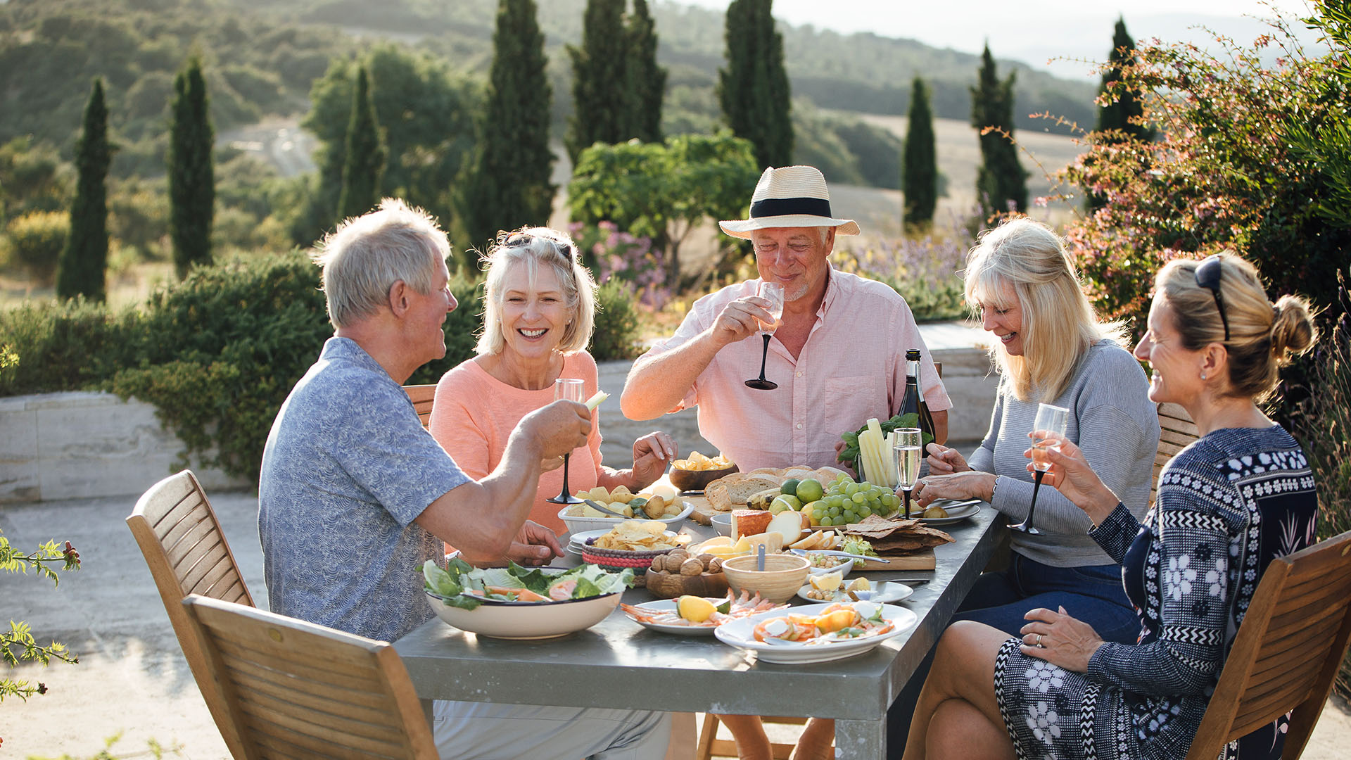 Group of people smiling while dining outside in Italy