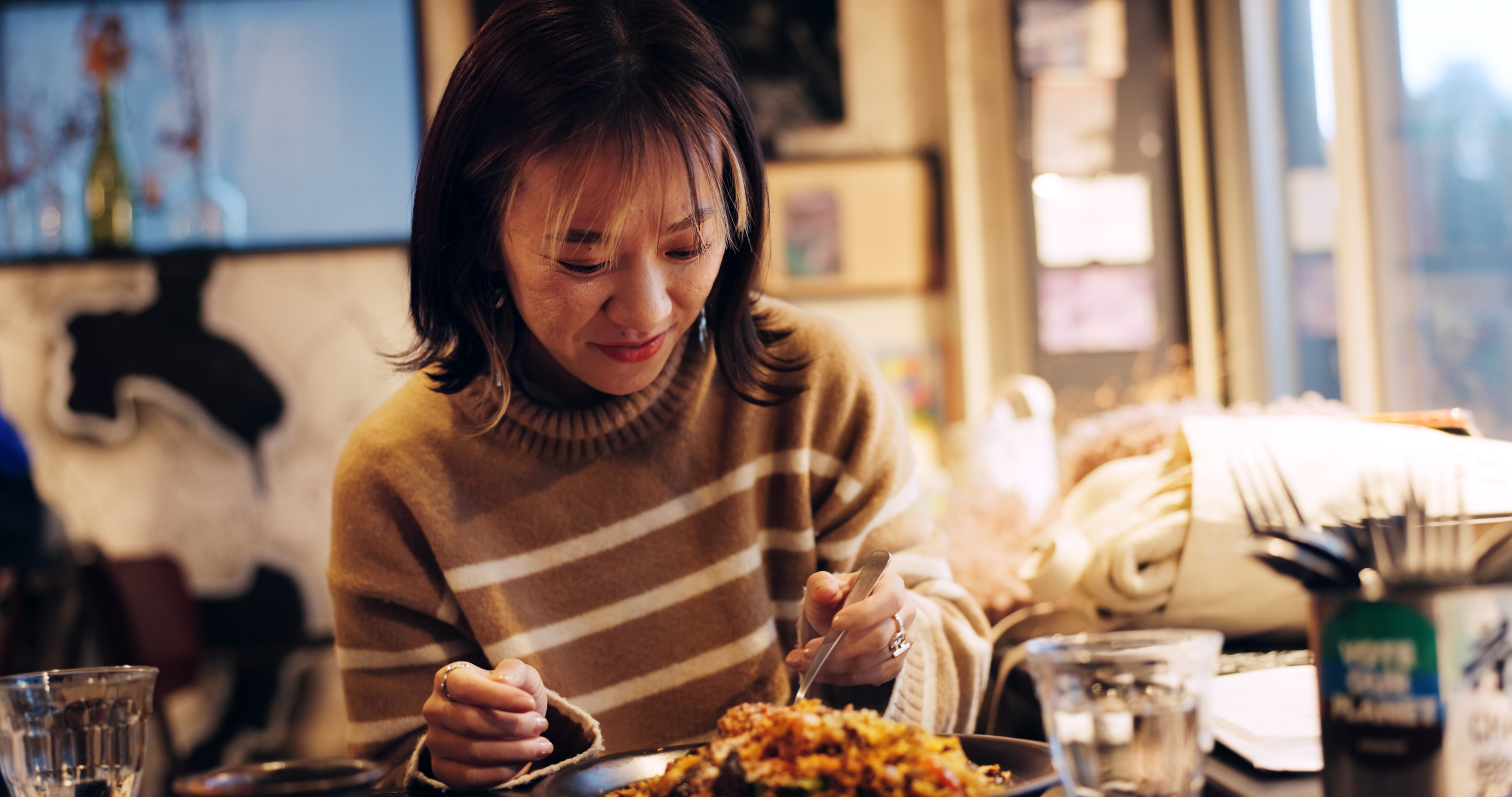 woman at a restaurant eating a meal