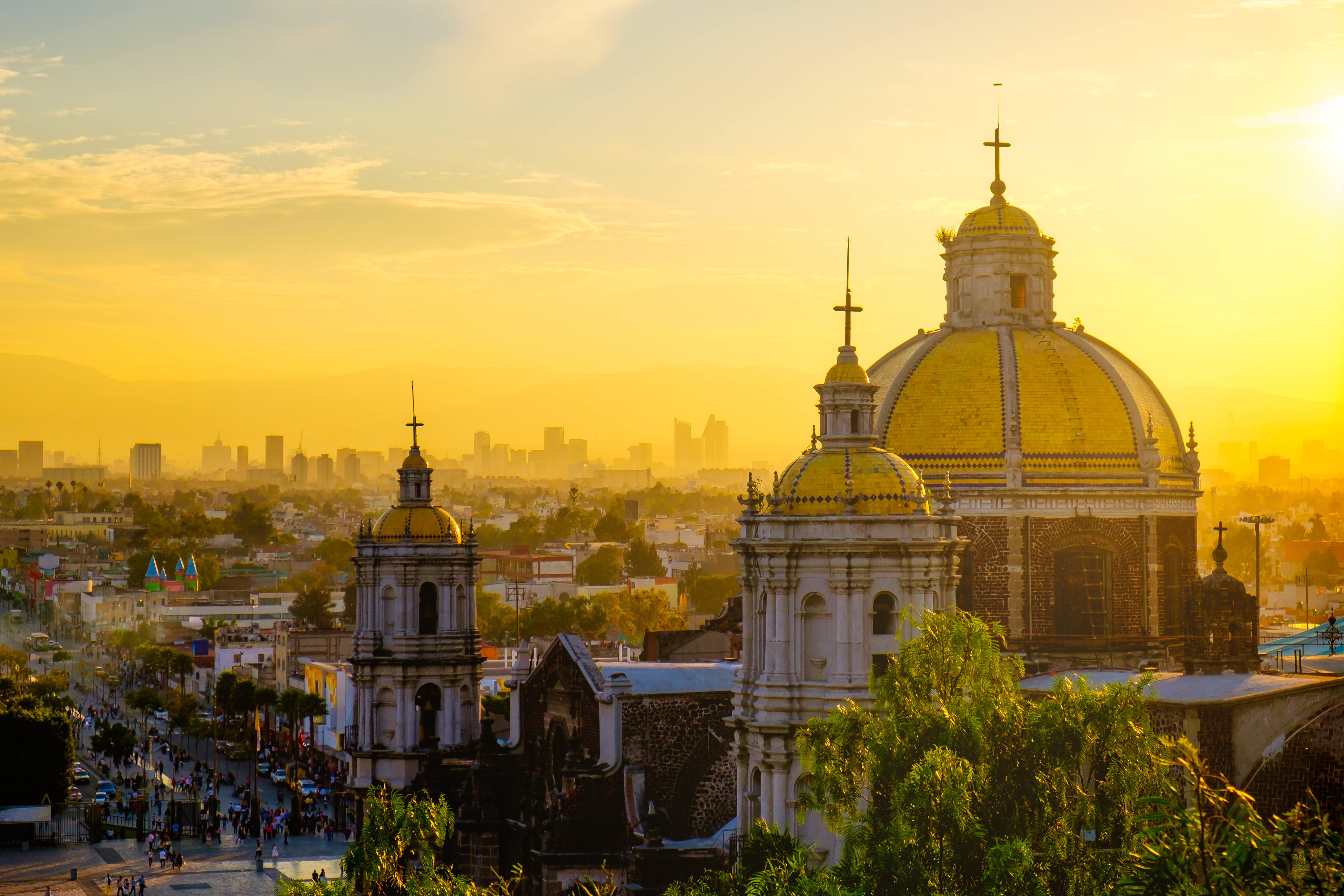 dome of a basilica overlooking a colonial city at sunrise