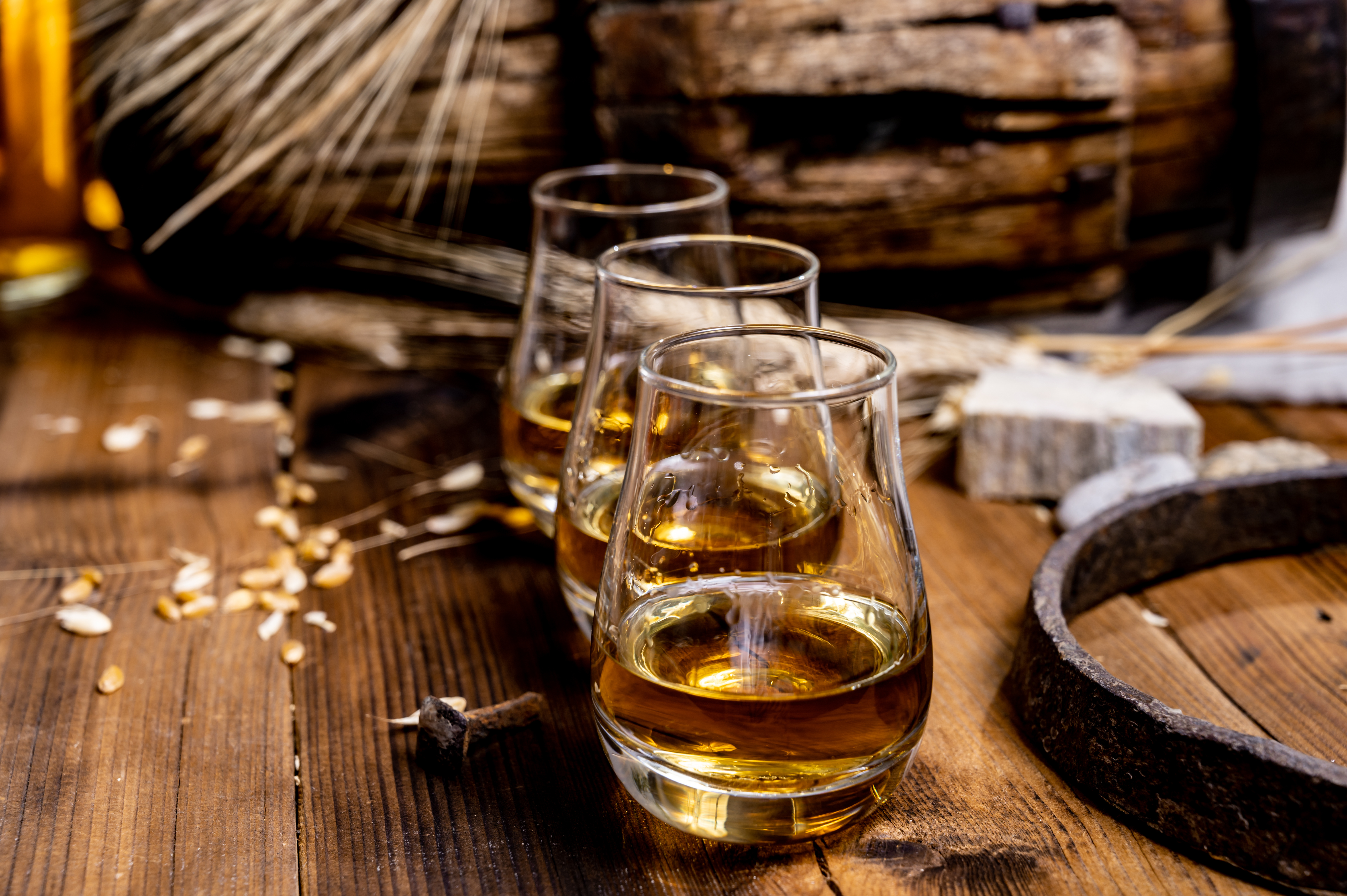 glasses of scotch on a wooden table