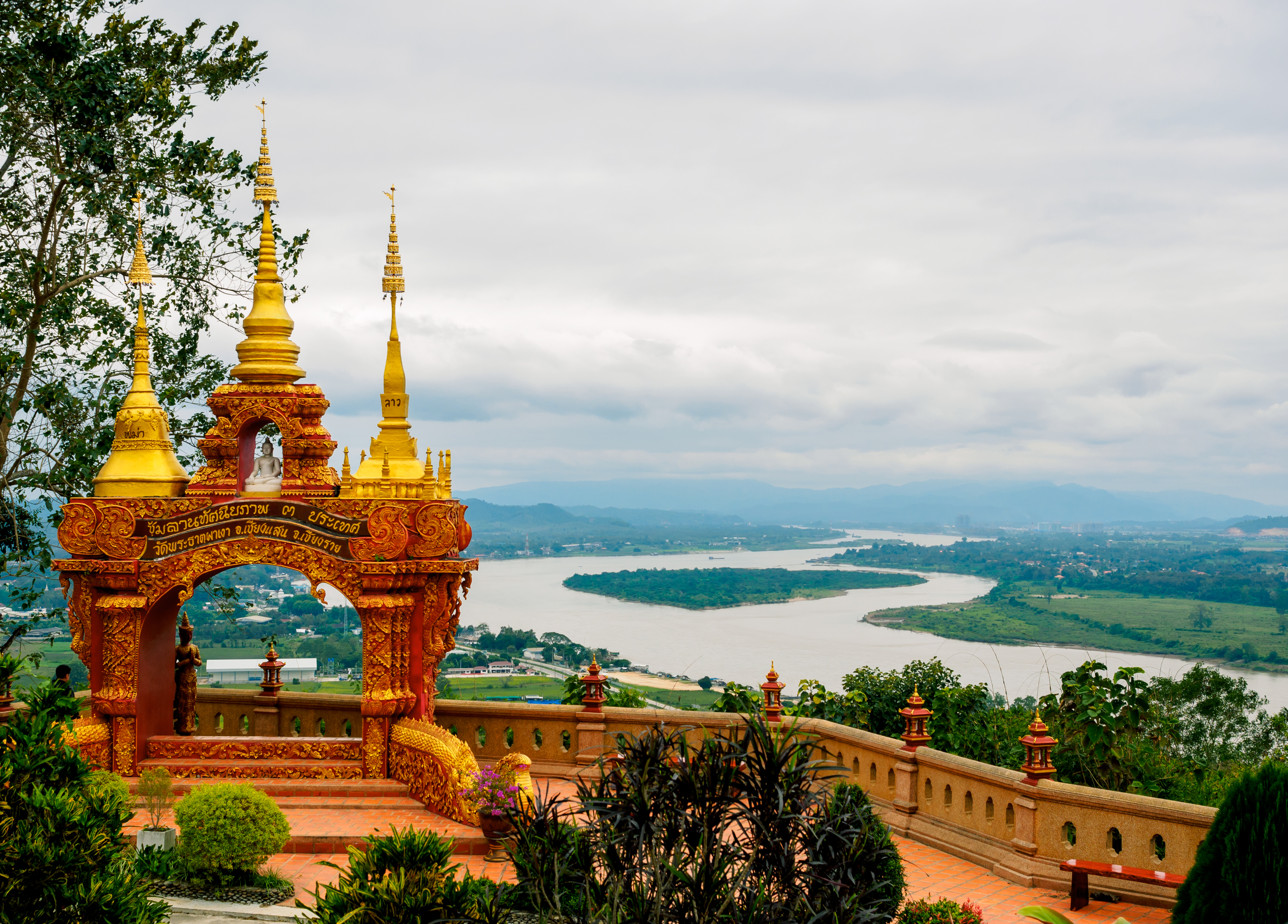 Arch with 3 golden pagodas representing Thailand, Myanmar, Laos at Pra Thad Pha Ngo Temple, Chang Saen, Thailand Vacations