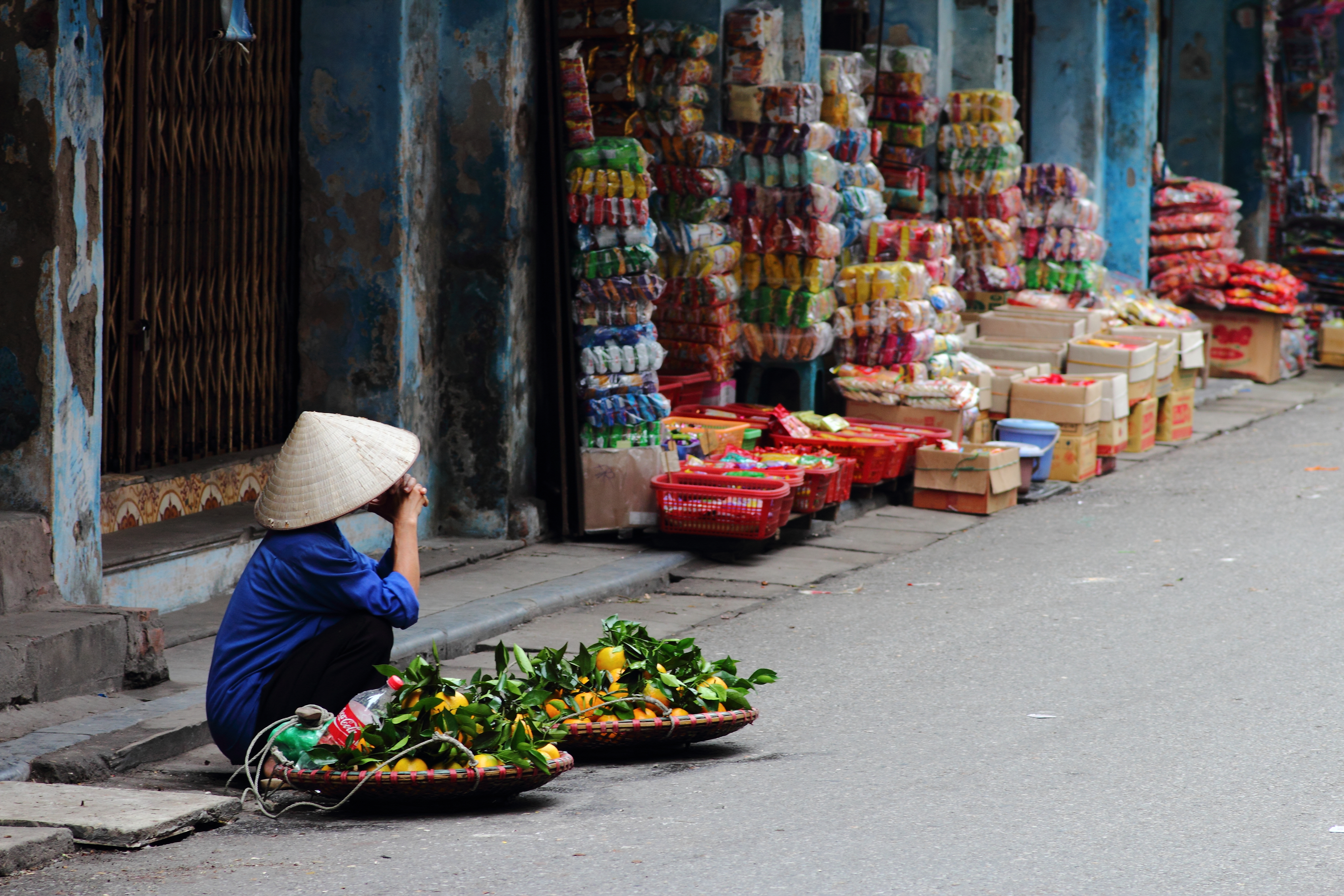 Street vendor in Vietnam selling fruit at a corner in Hanoi, Vietnam