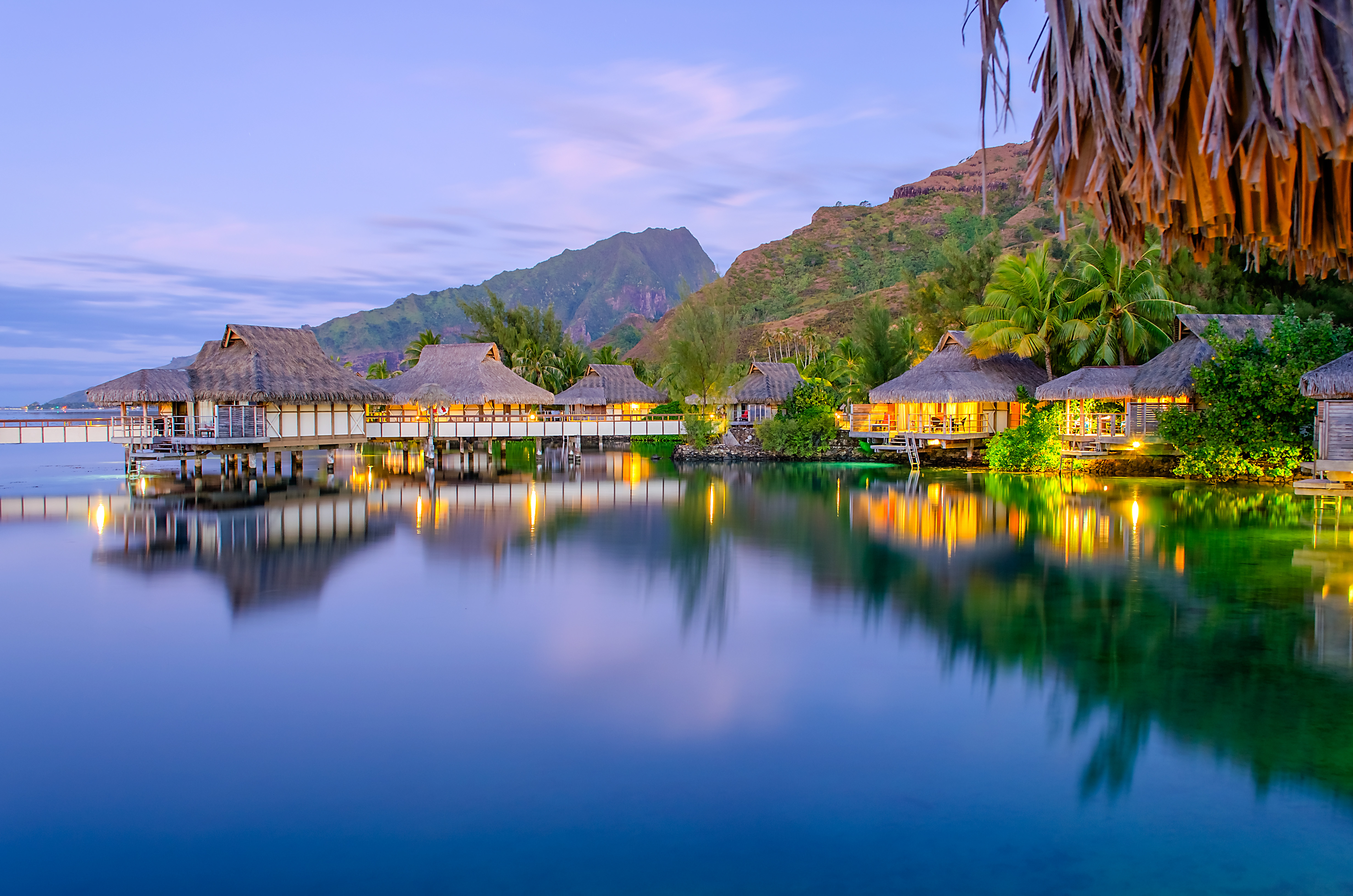 Overwater bungalows at dusk, Tahiti Vacations