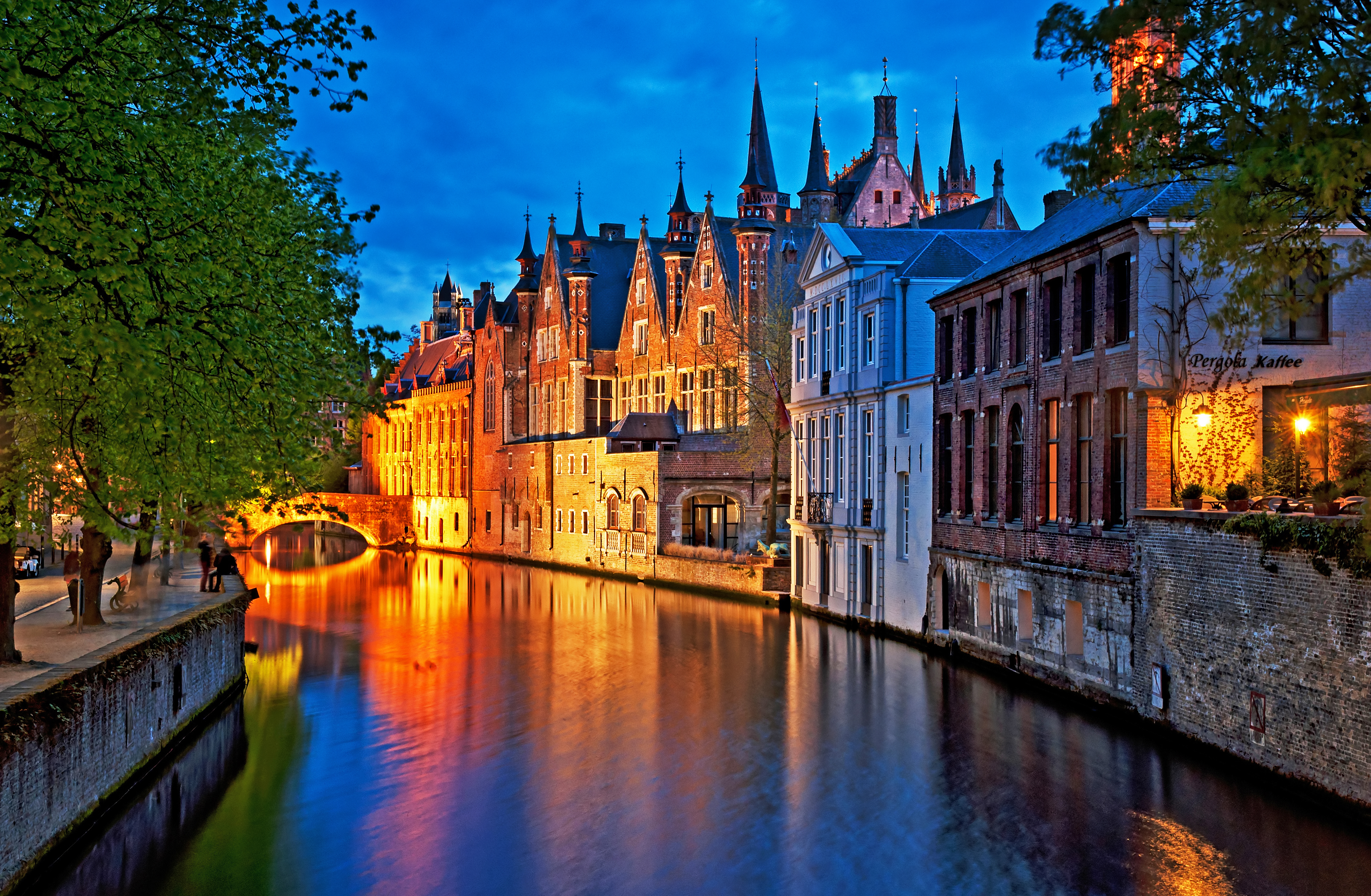 Night shot of historic medieval buildings along a canal in Bruges, Belgium