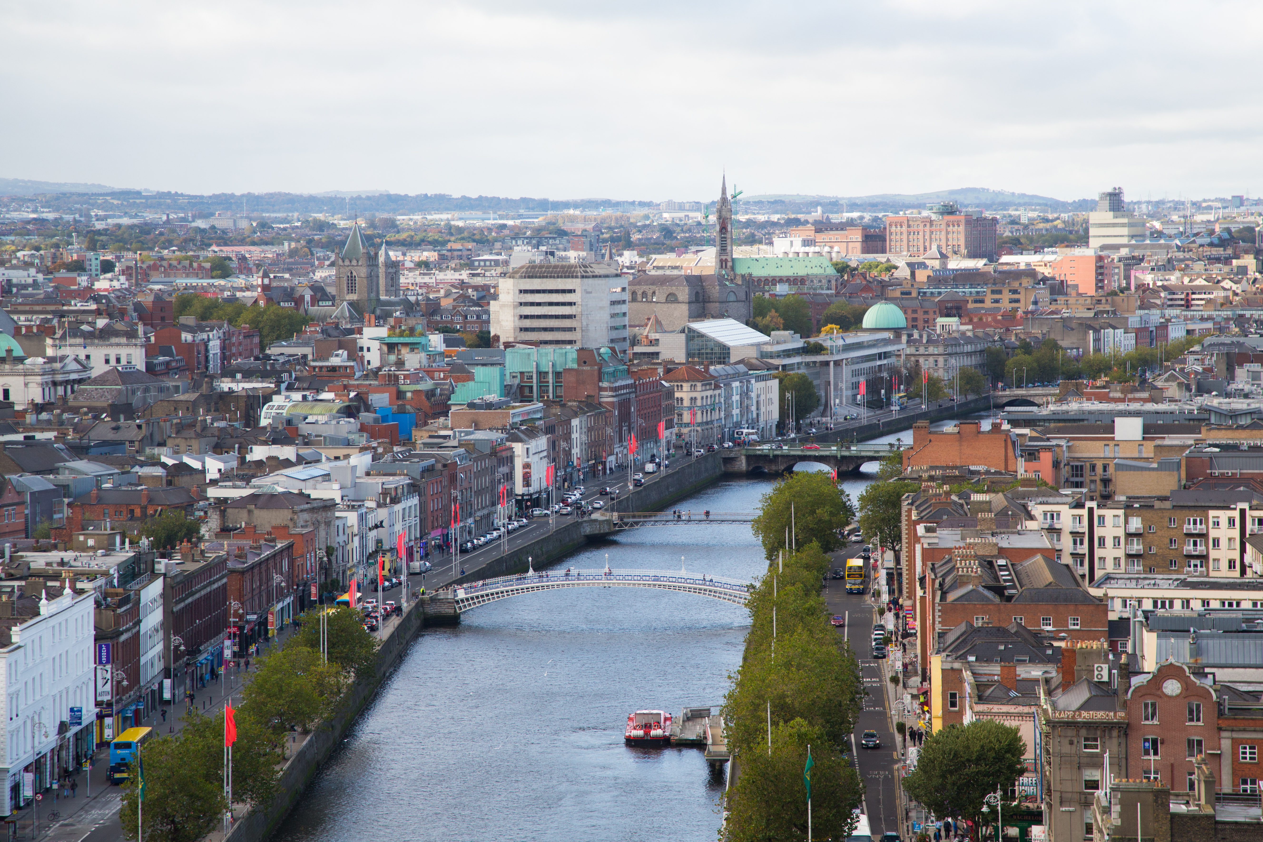 aerial view of a city alongside a river with bridges and old buildings