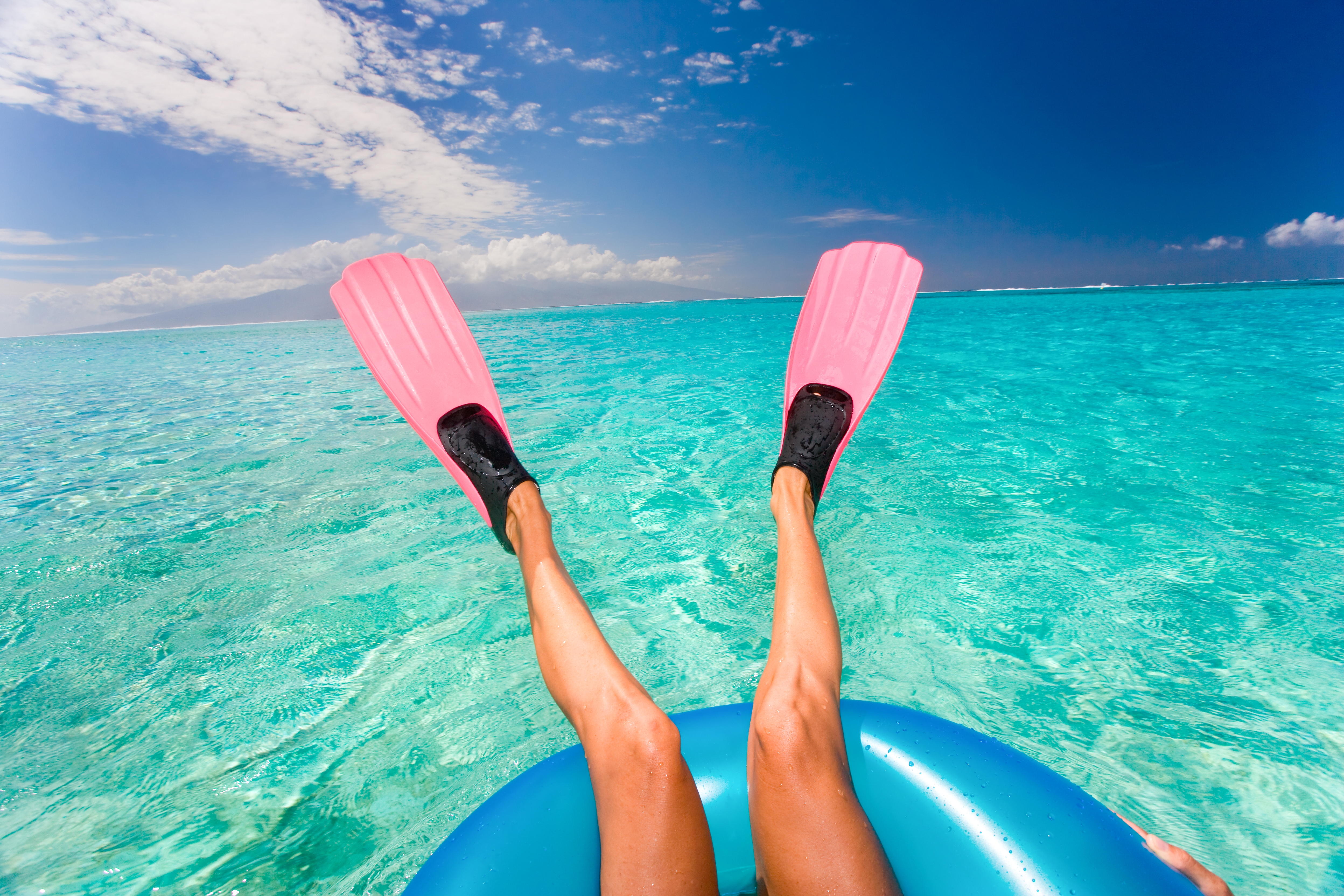 Woman with Pink Fins Floating in Turquoise Waters