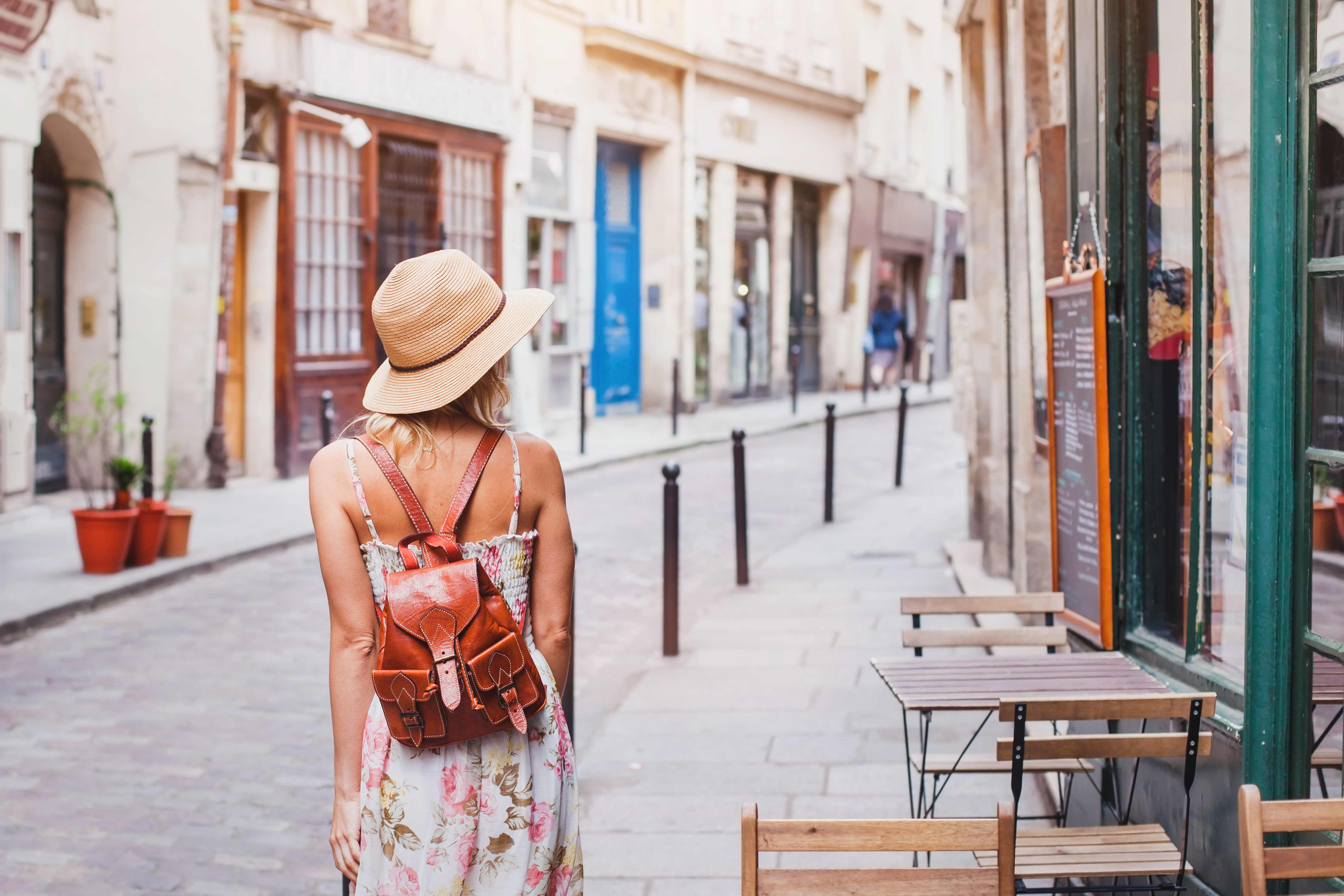 Young woman tourist walking on a street in Europe