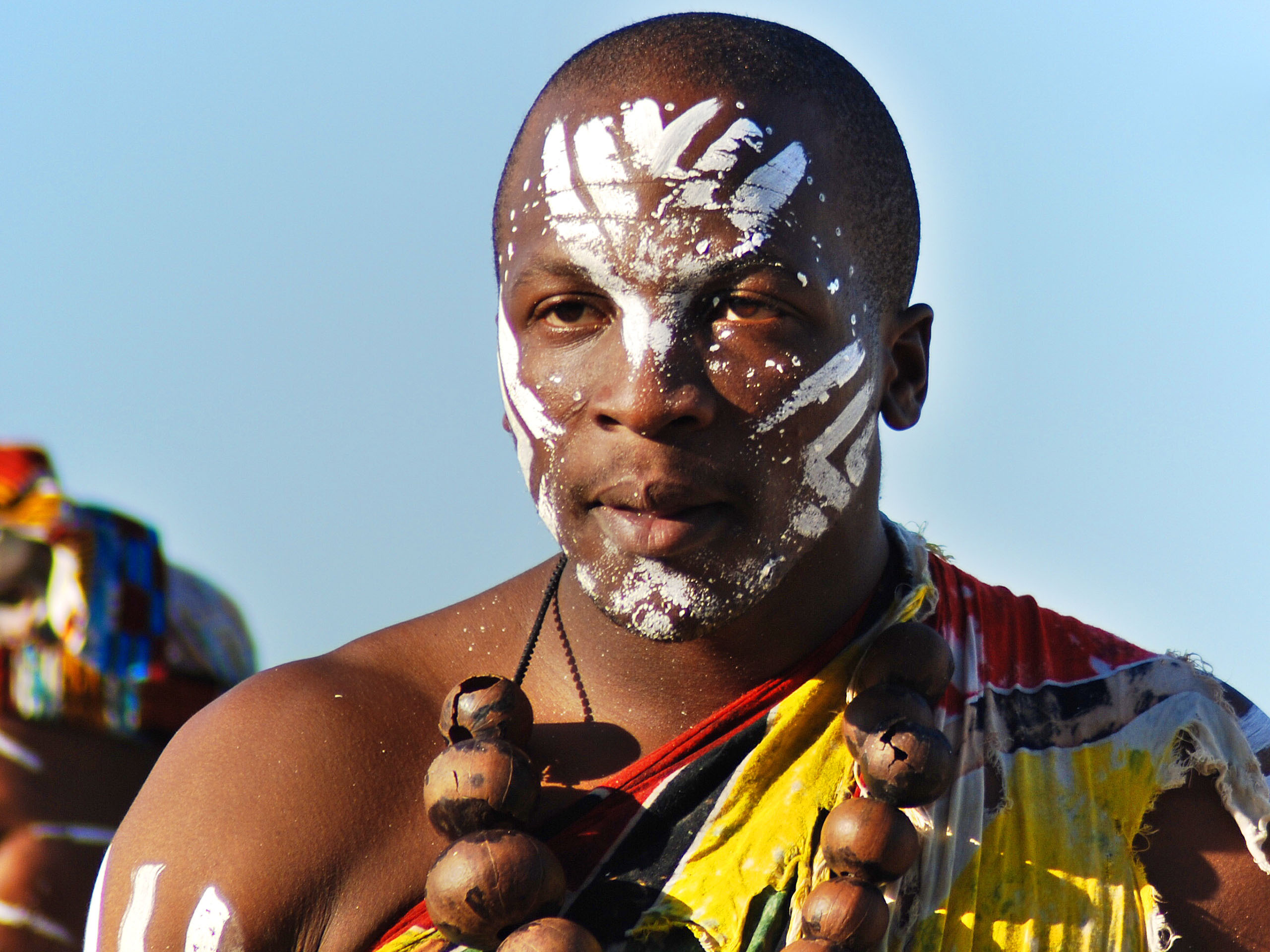 Young man wears traditional clothing during presentation of a Zulu show