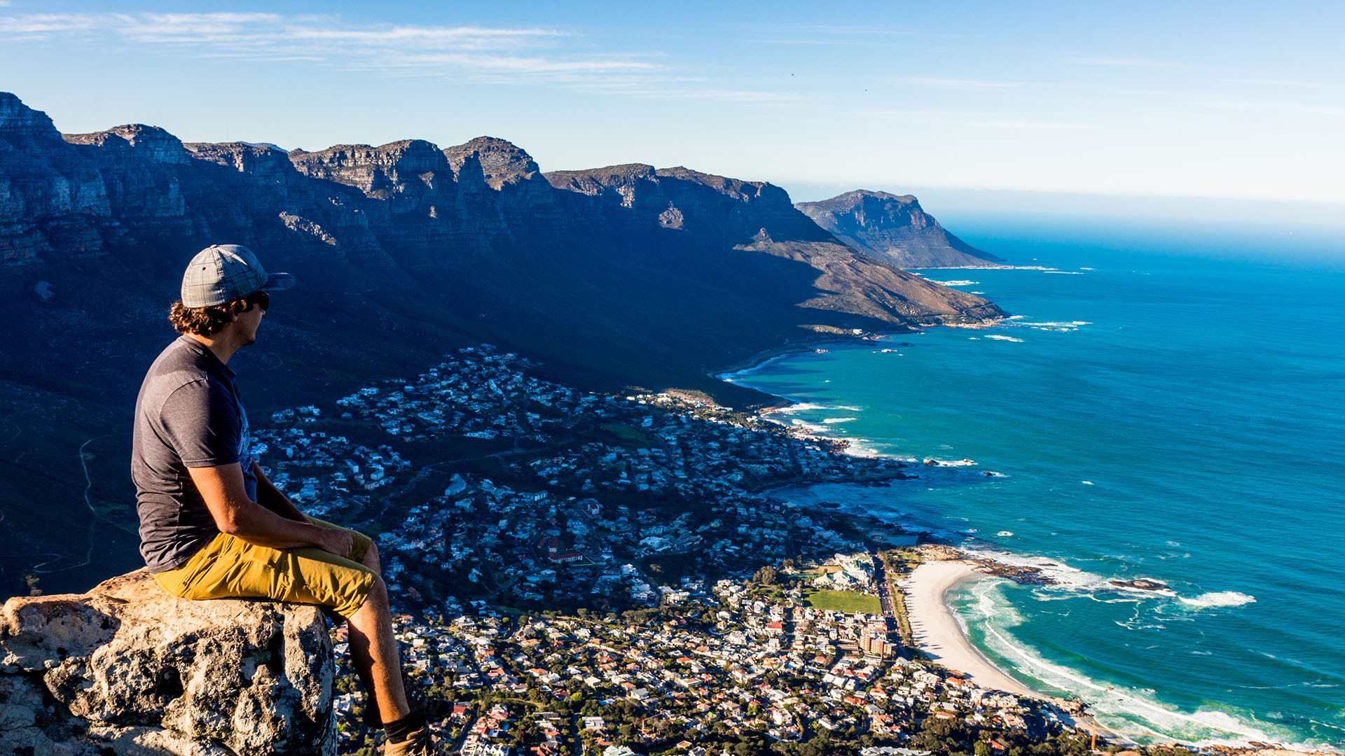 A man overlooking Cape Town from a ledge on Table Mountain