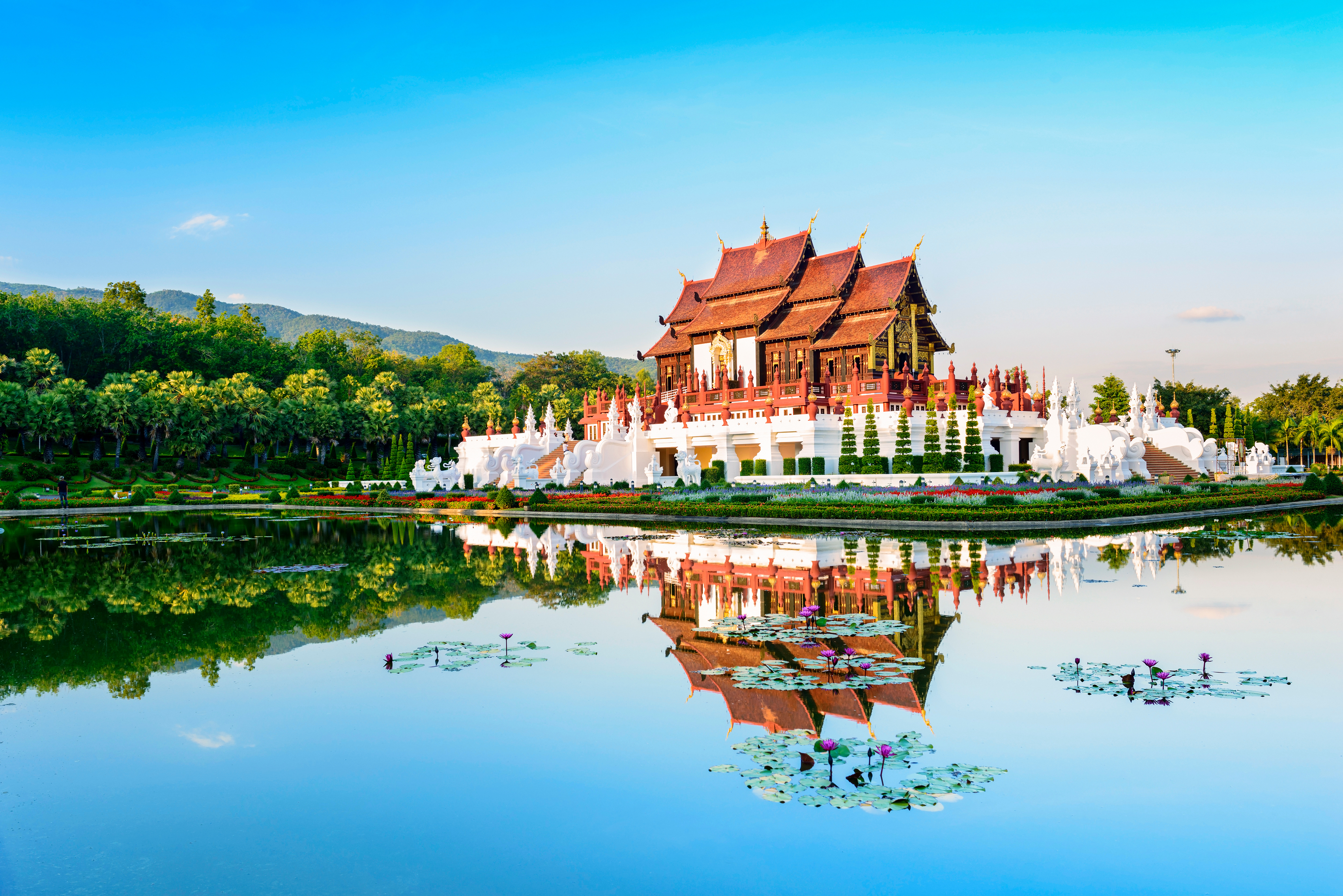 A temple in Chiang Mai, Thailand creates a perfect reflection in the surrounding pond.
