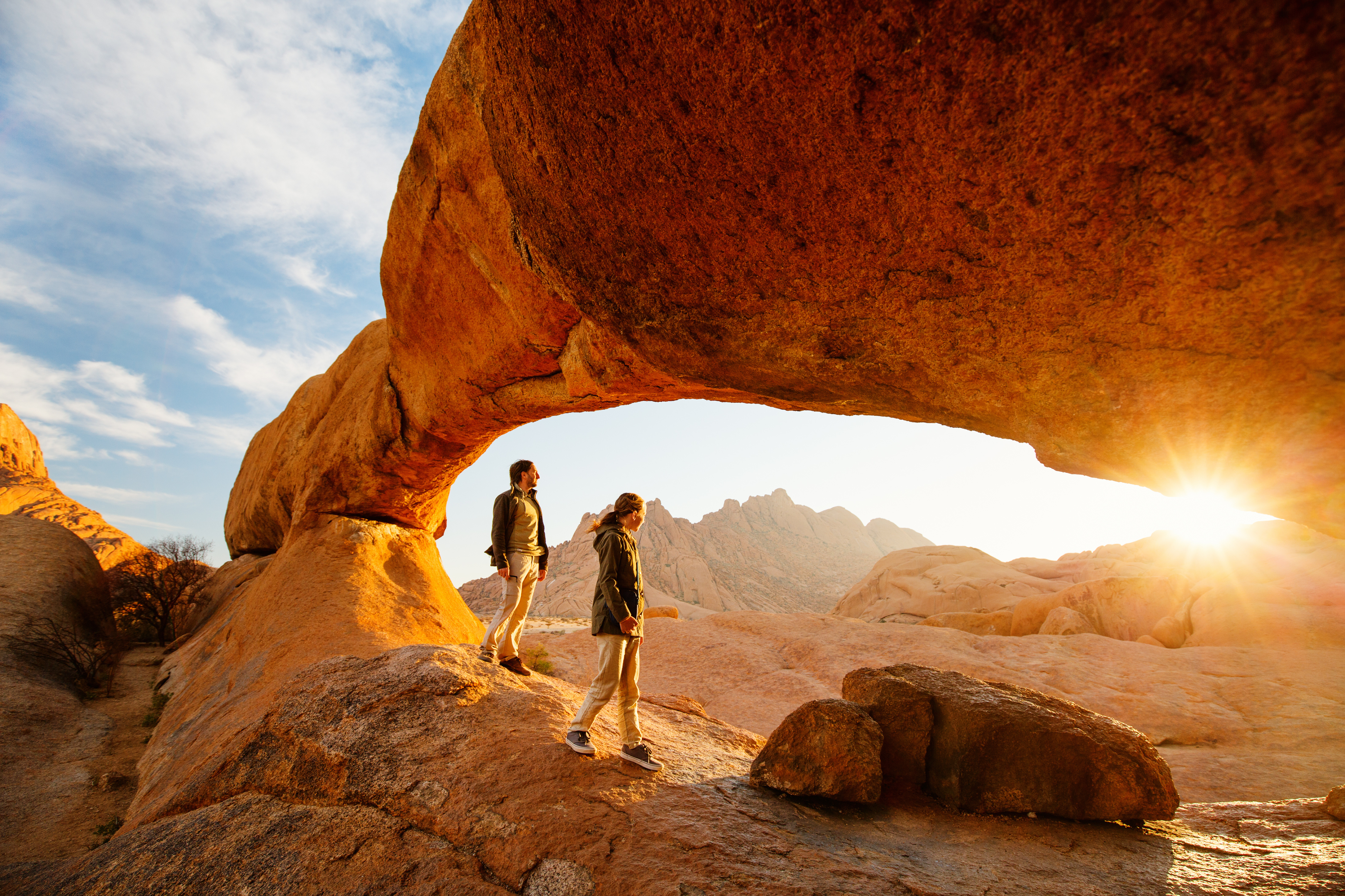 sunrise red rock people hiking