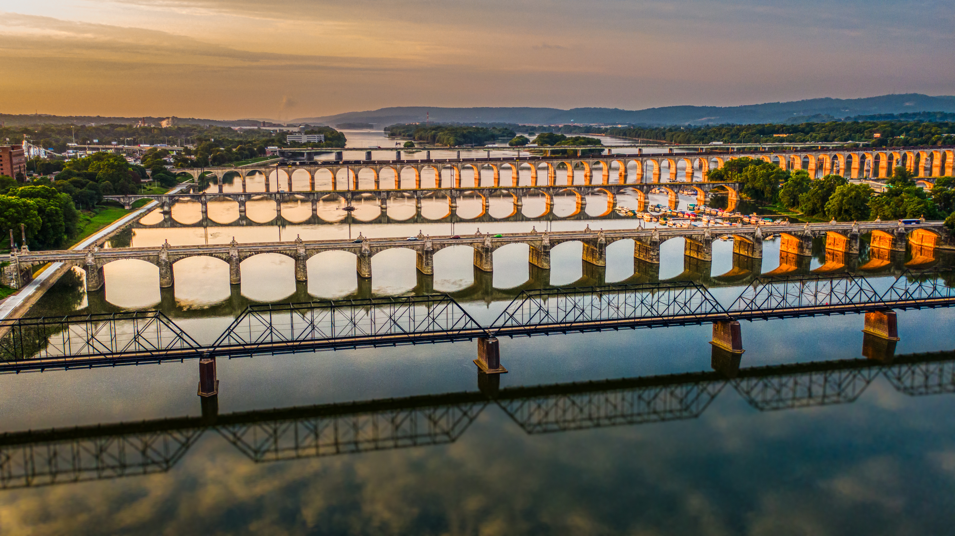 Many bridges over river in sunset, Harrisburg, Pennsylvania, Susquehanna River crossings aerial view