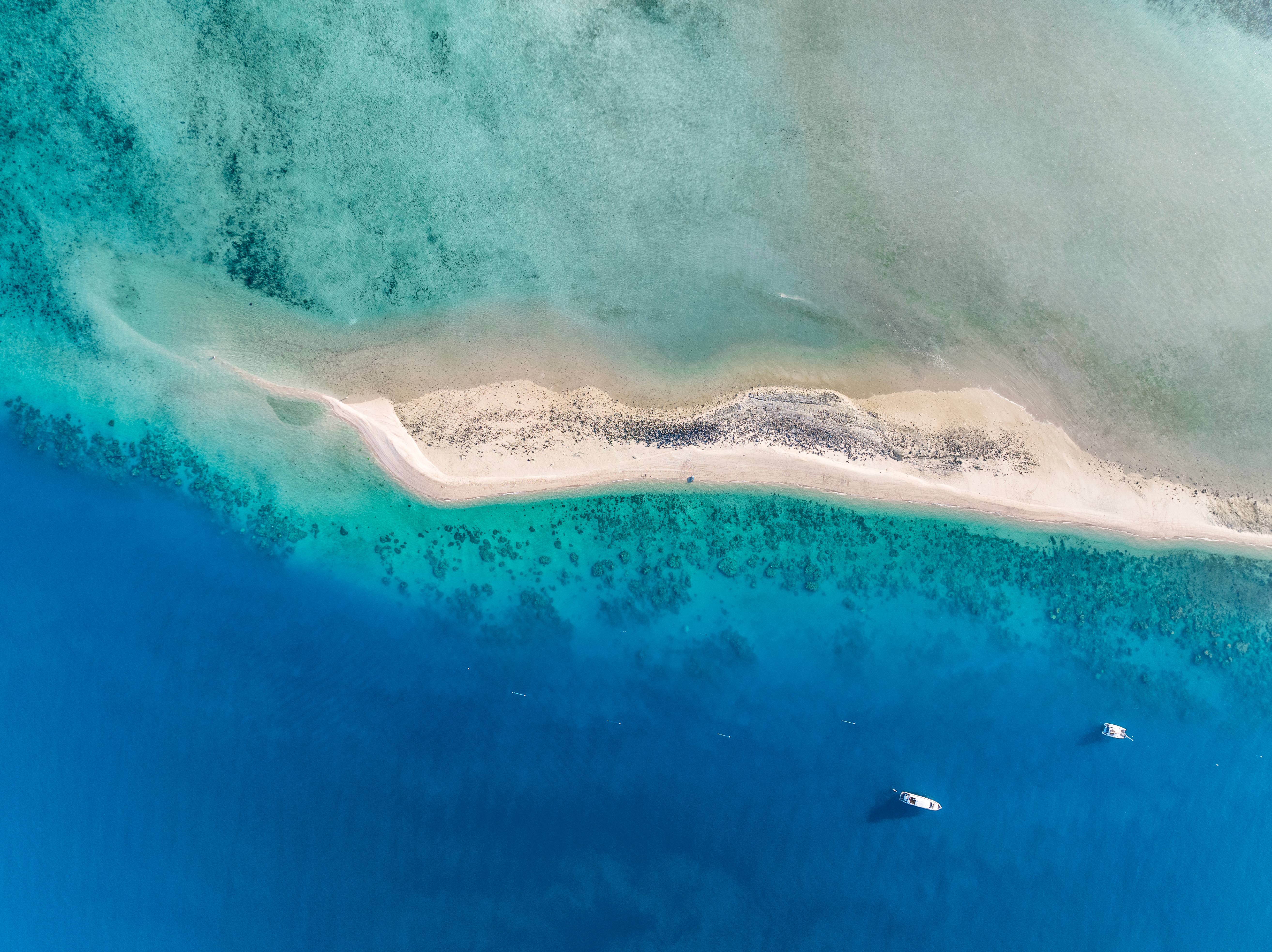 High angle aerial drone view of the sandbar and blue waters