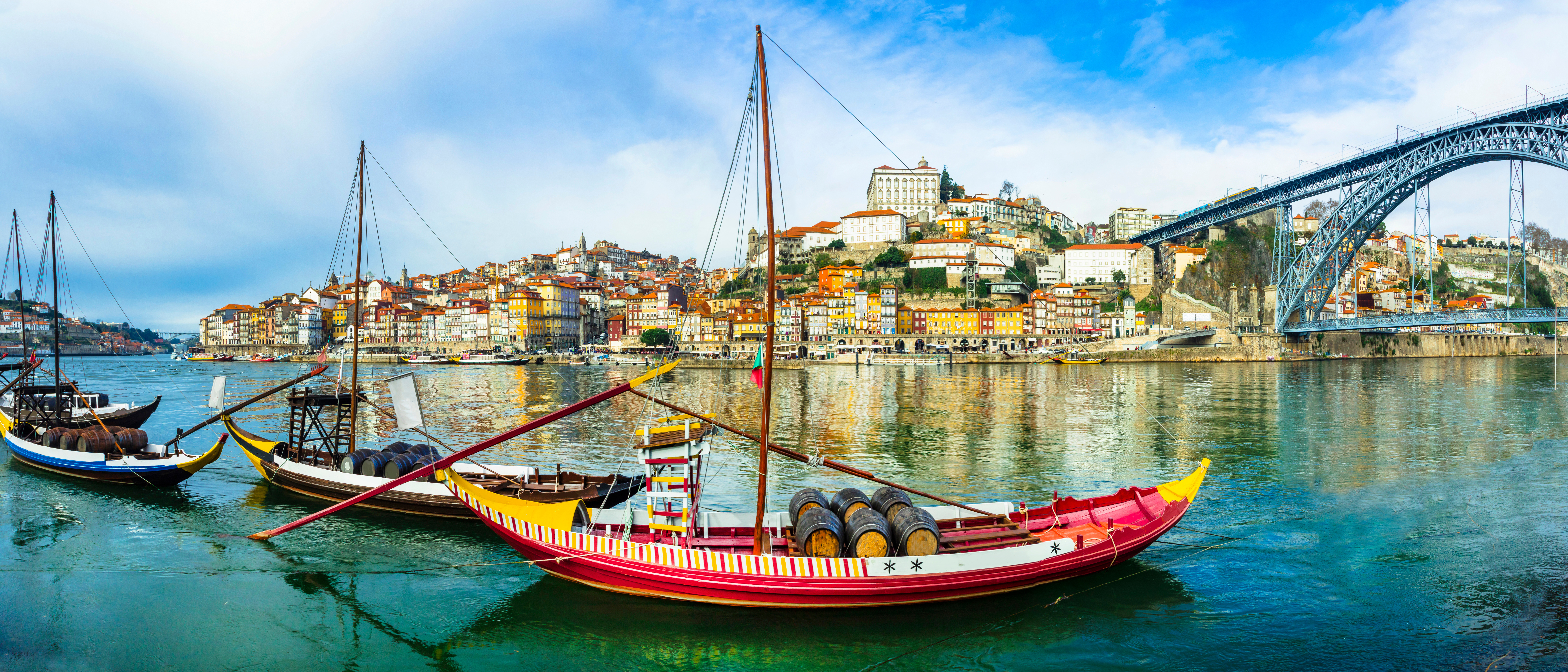 Panorama of beautiful Porto with traditional boats on the river