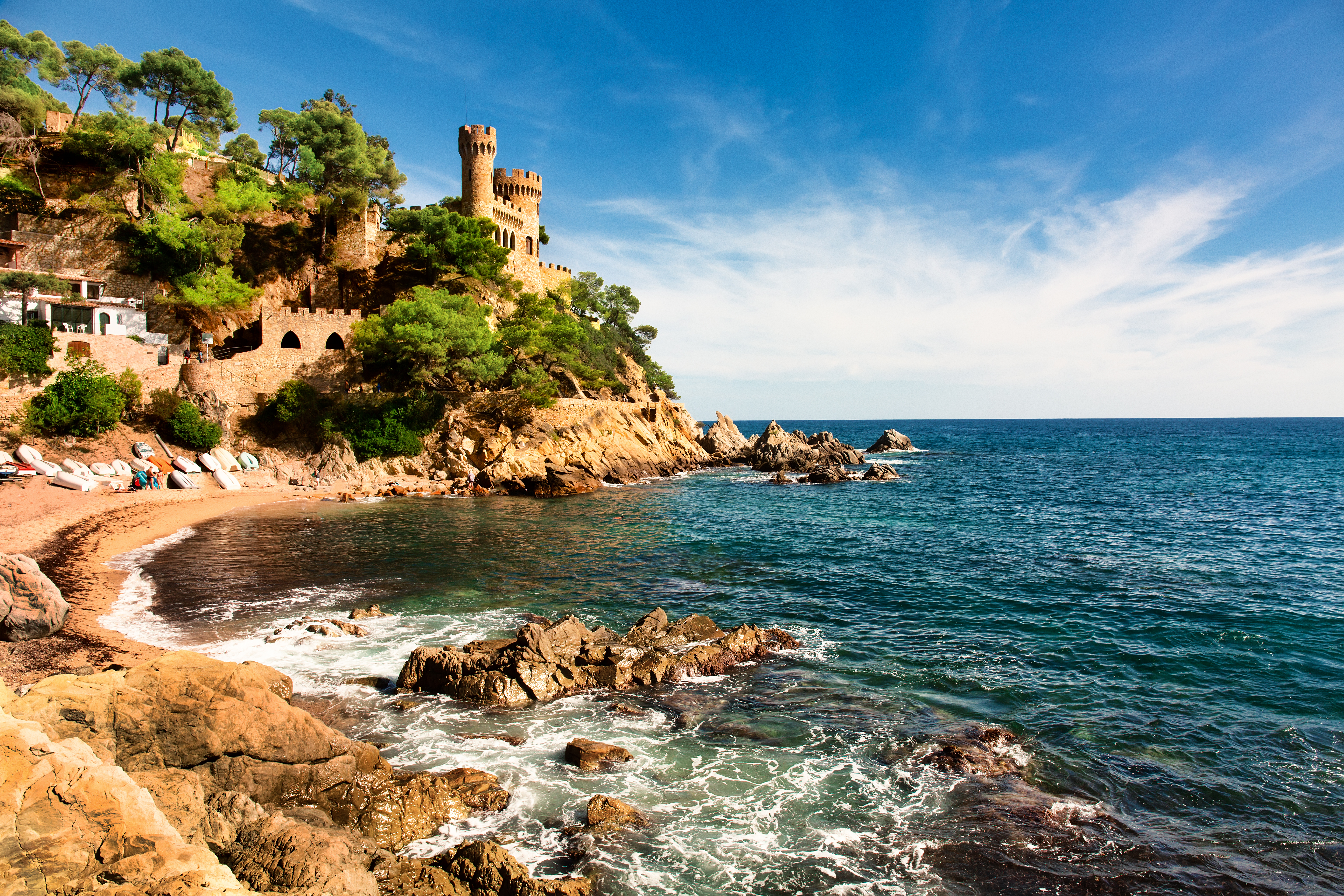 Medieval castle overlooking balearic coast and stunning beach
