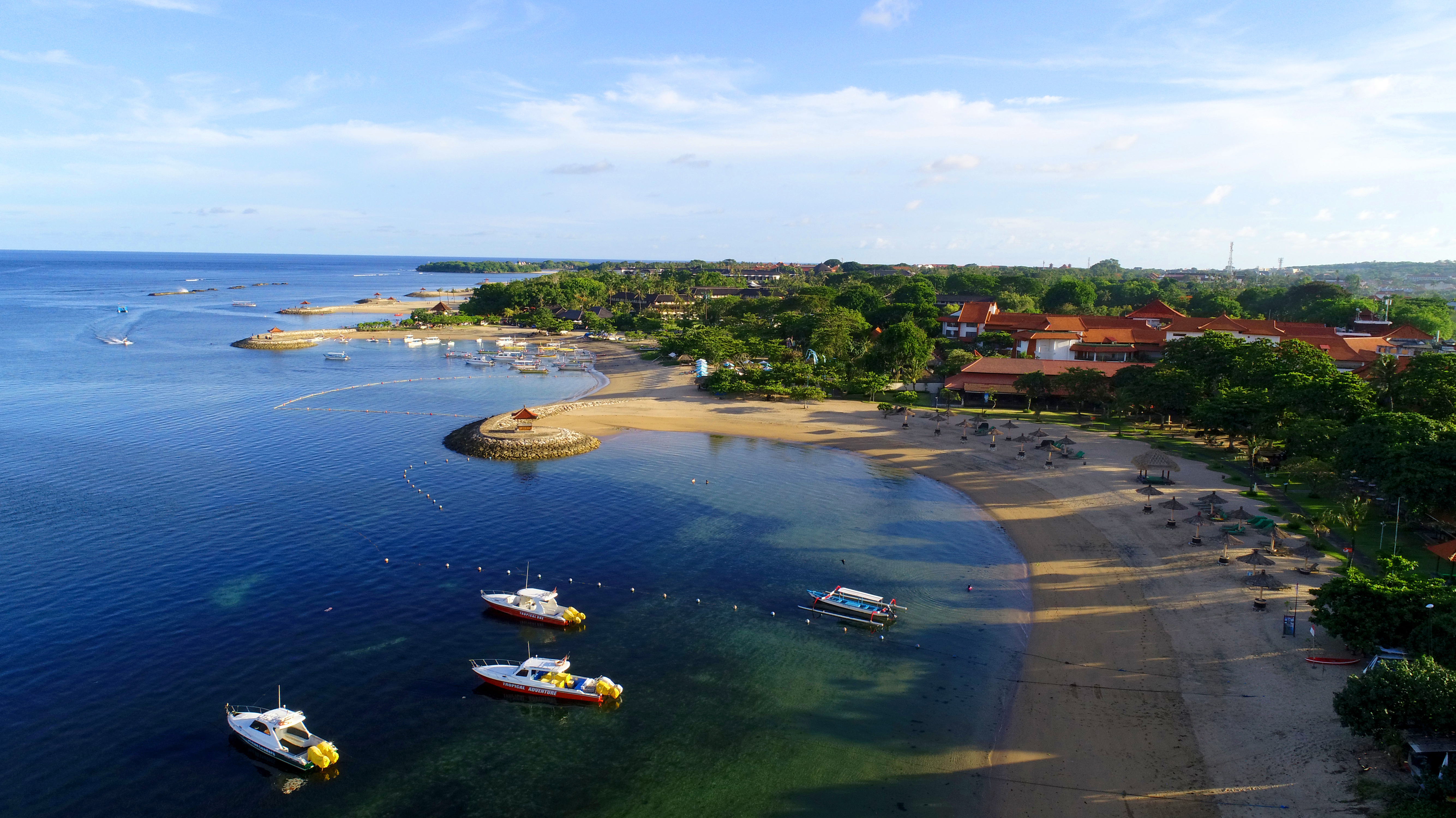 Beautiful aerial view of Tanjung Benoa Beach with boats in the water