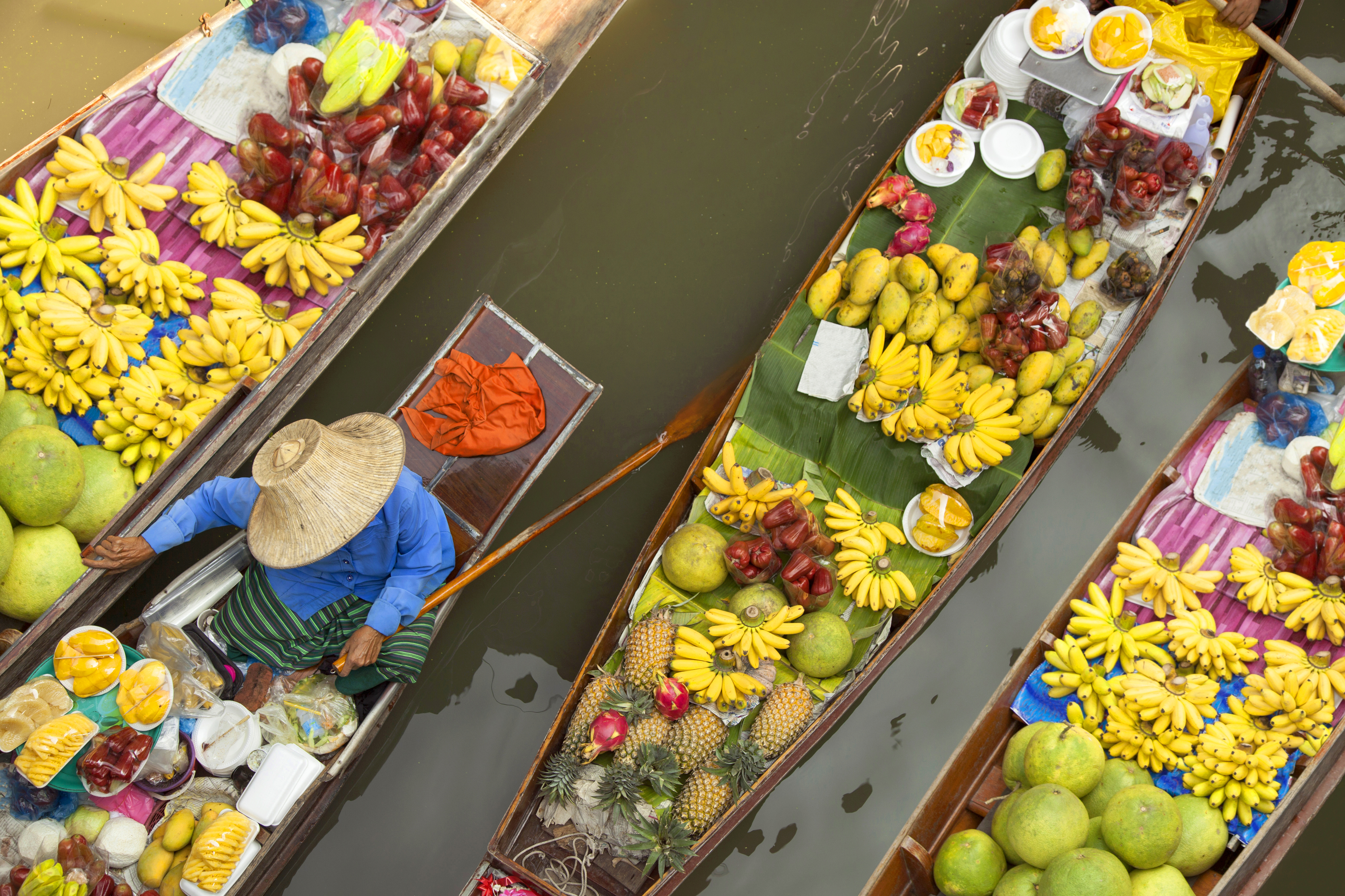 Floating market, boats filled with fruits and vegetables, in Bangkok, Thailand 