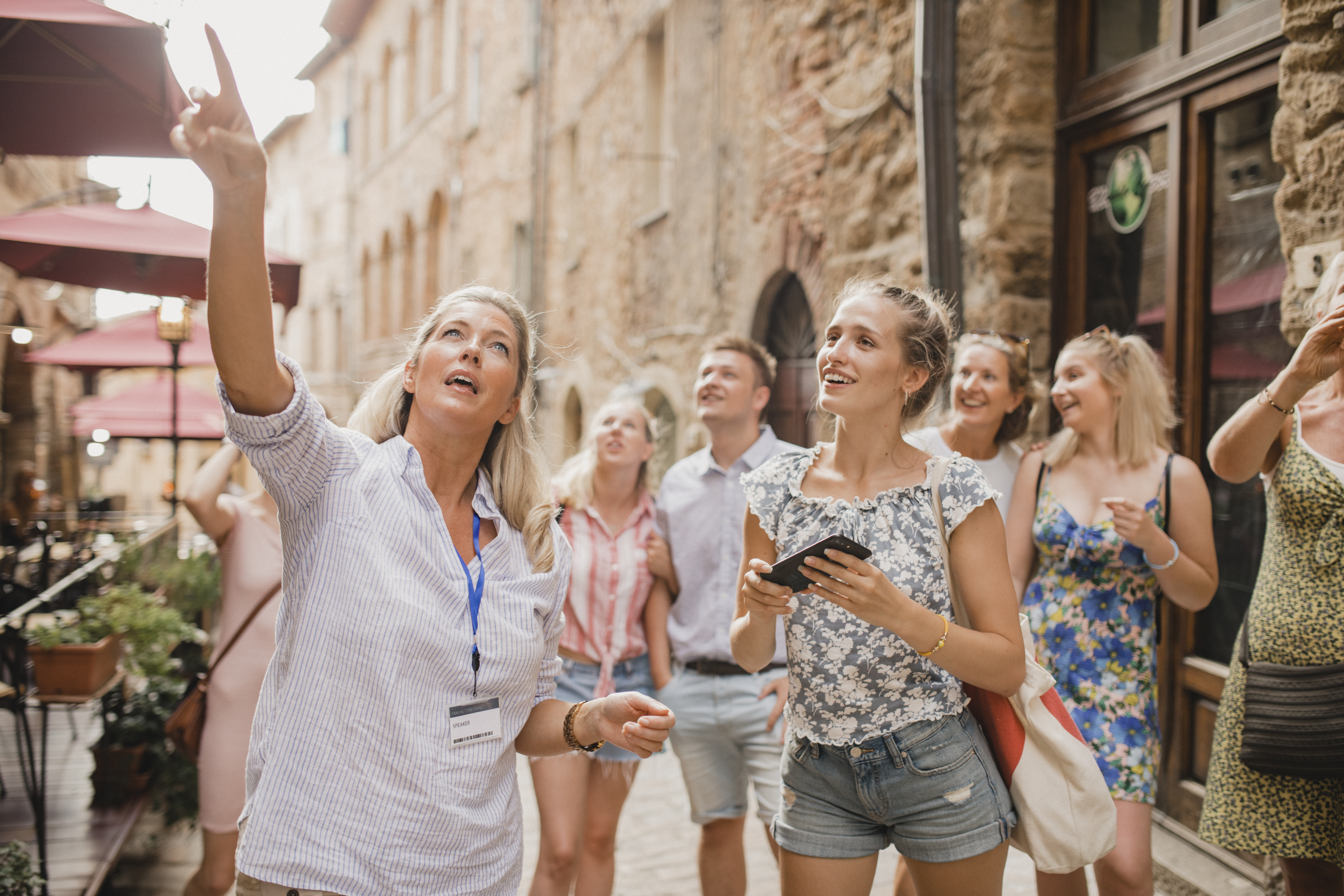 Group of people standing in a street in Volterra learning about architecture and the history