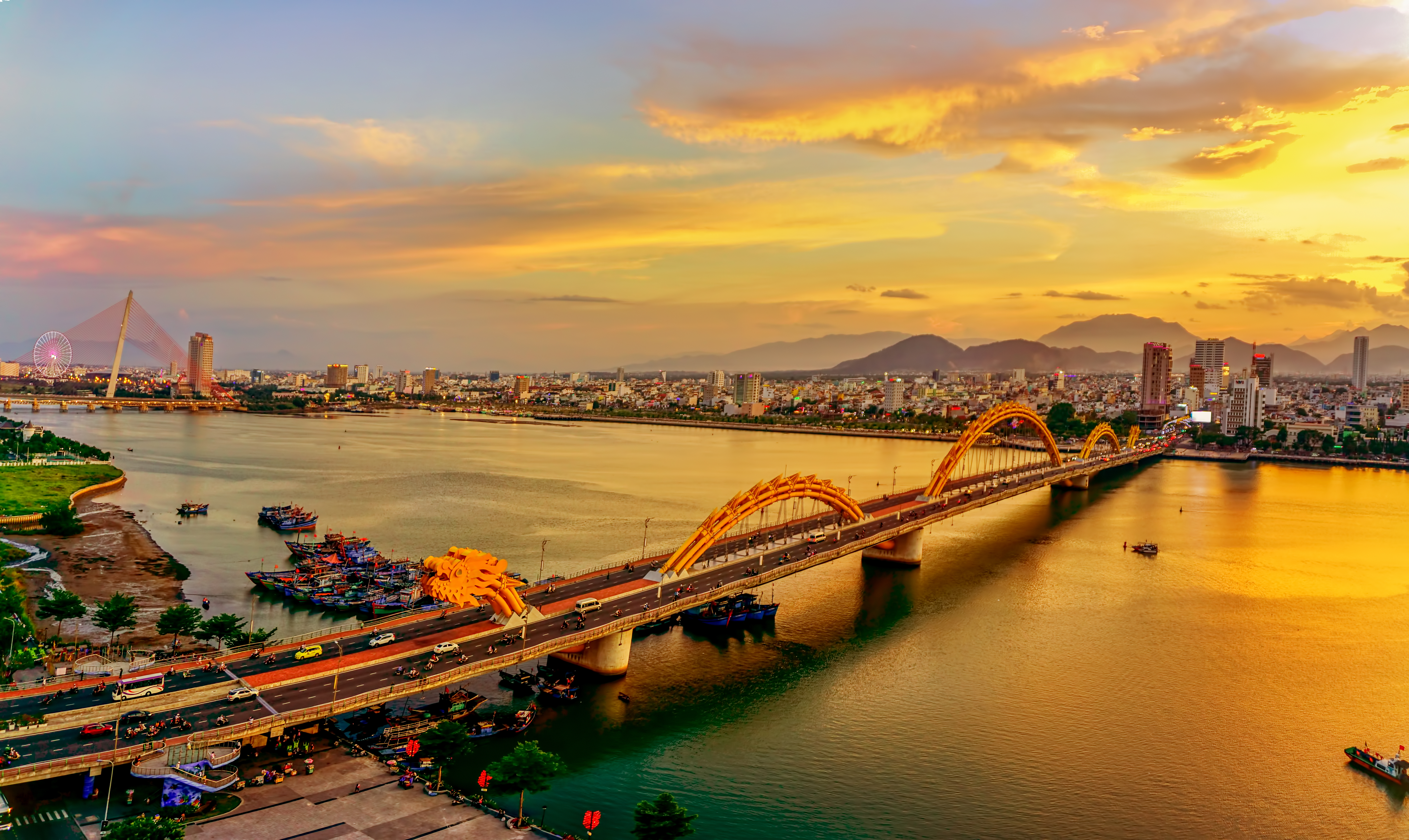 View of a 2,185-foot-long bridge shaped like an undulating golden dragon is the most famous bridge over the Han River in downtown Danang