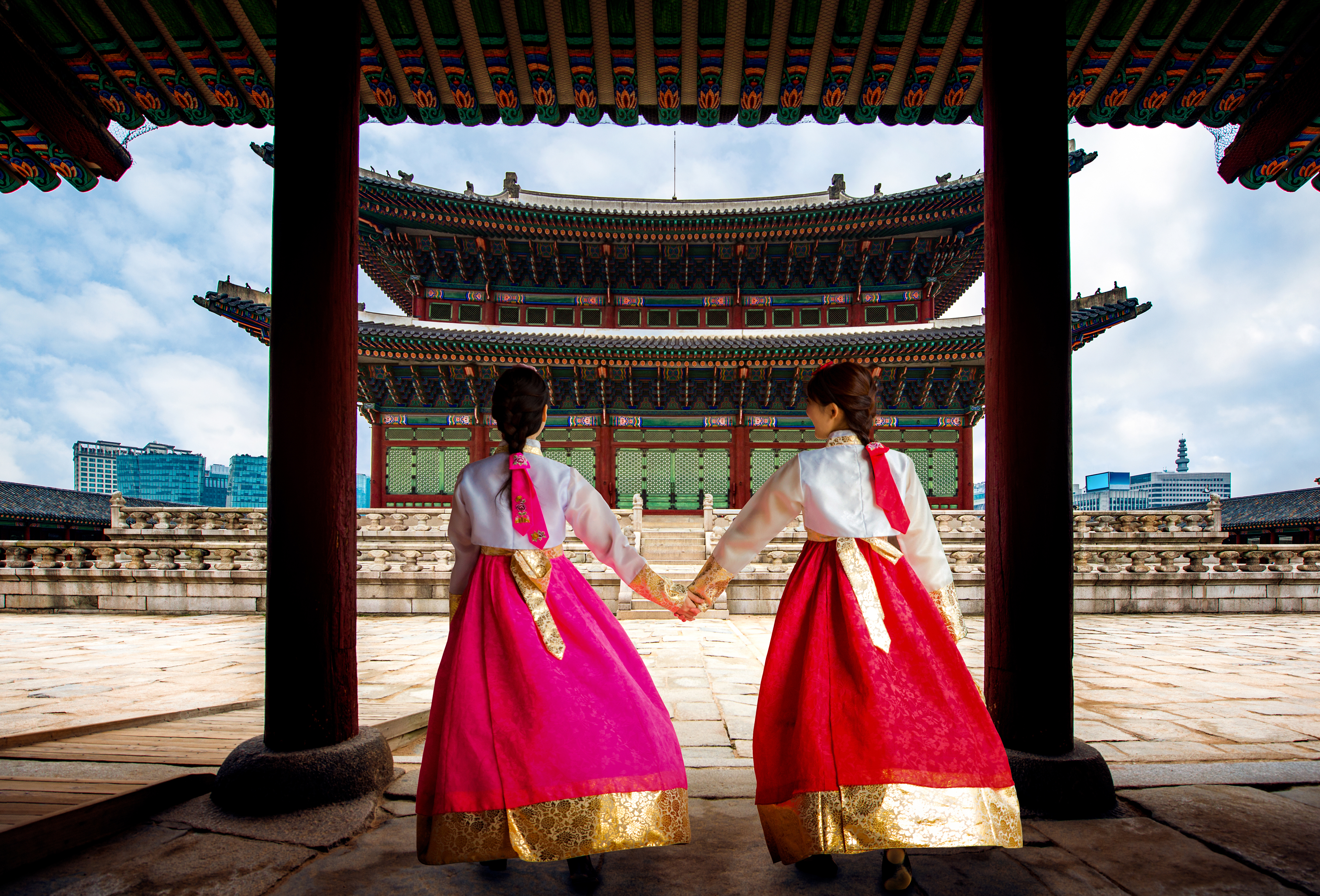 Korean women in Hanbok or Korean Gress, walking at Gyeongbokgung Palace in Seoul, South Korea