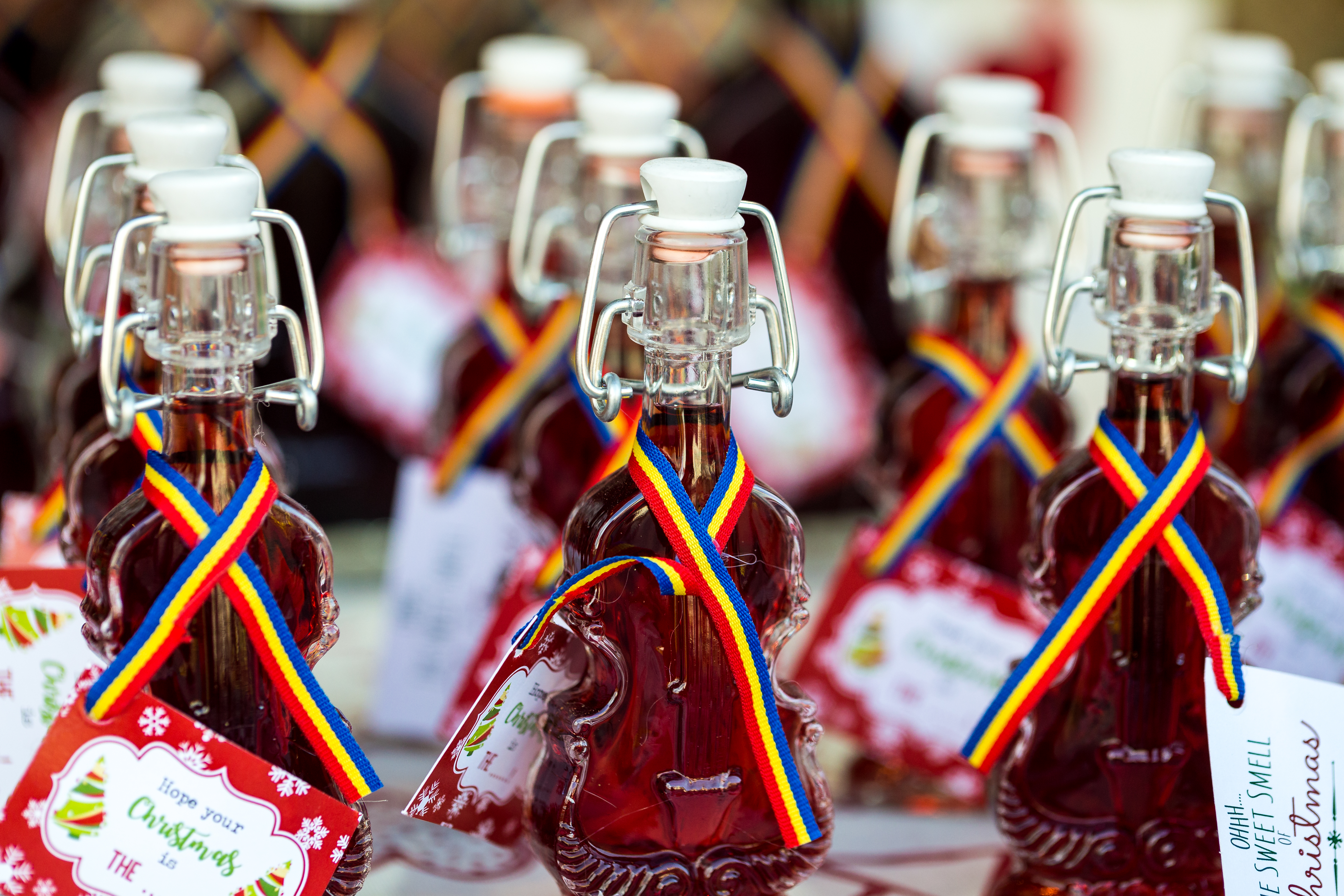 Bottles of Romanian visinata - a liqueur made from sour cherries - in a row and for sale at a food and drink market in Transylvania